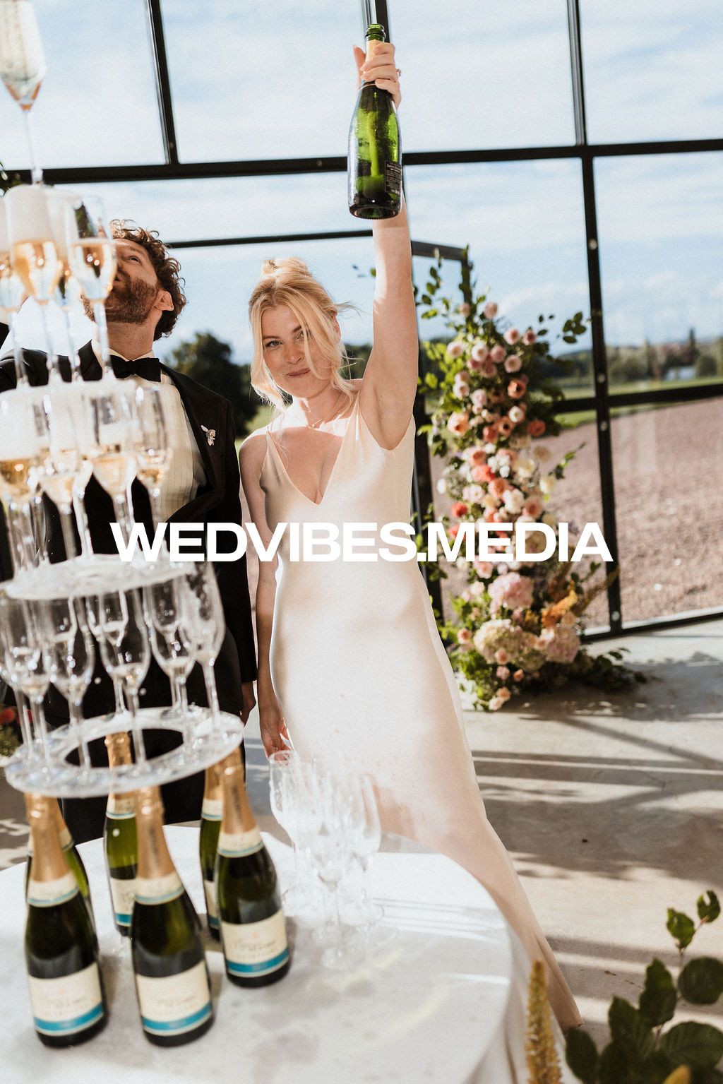 Luxury wedding details: Champagne tower on a sunny terrace at domaine du reveillon by Raw Studio, editorial destination wedding photographer