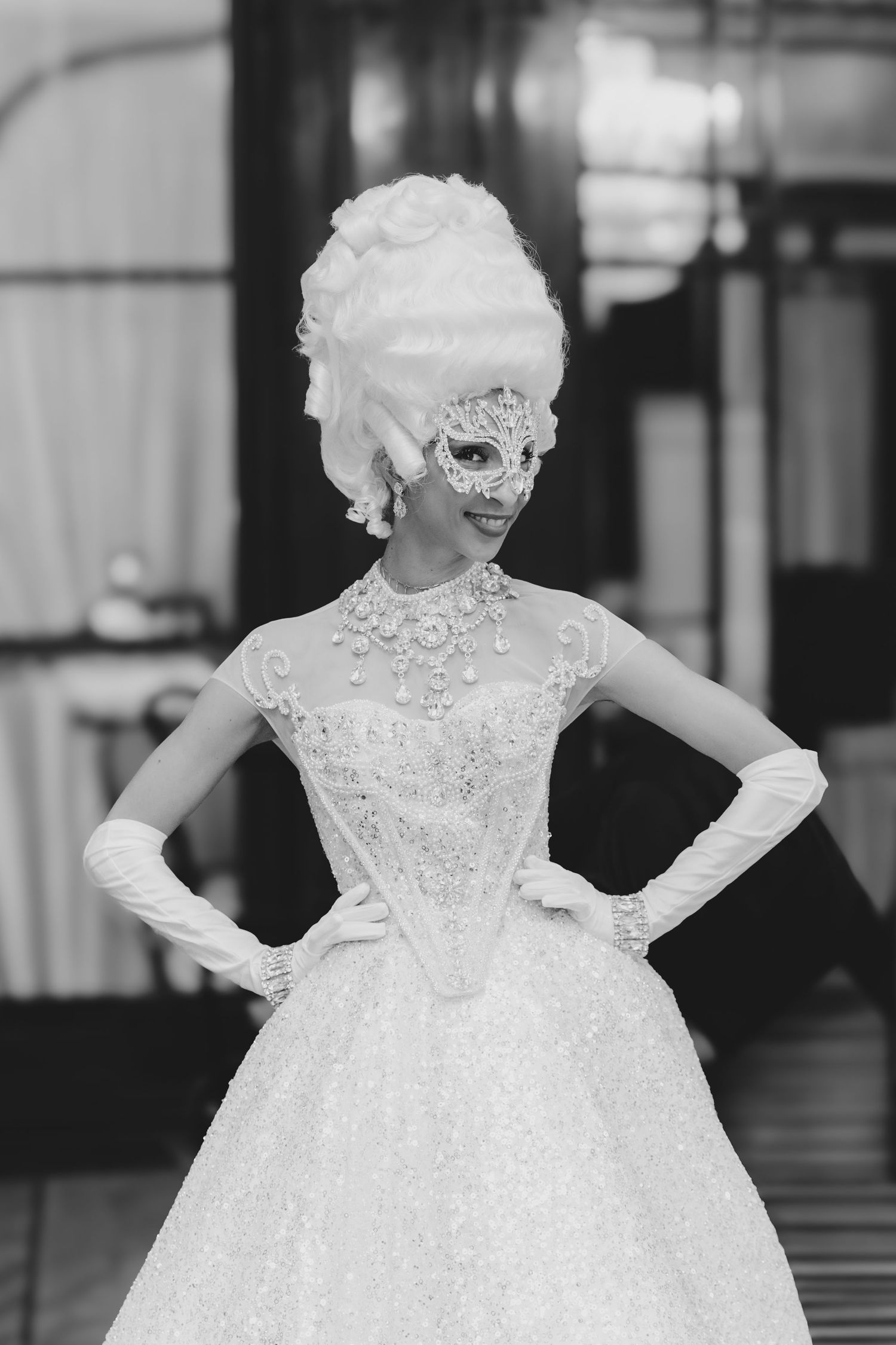 Elegant white ball gown with intricate beading and full skirt displayed in a formal setting.