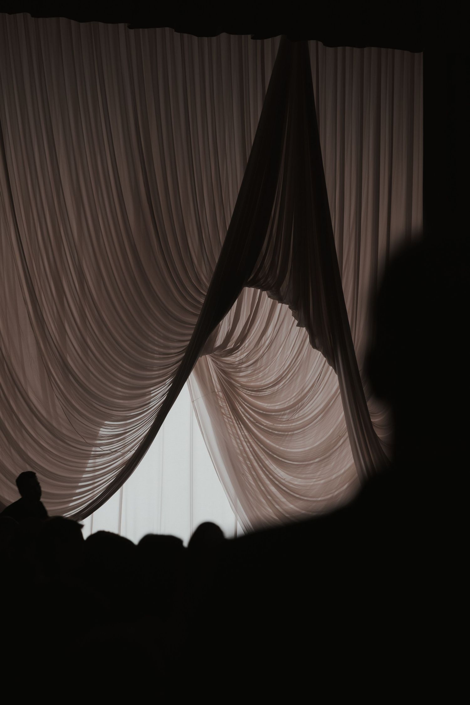 A sequence of dark curtain photos showing progressive movement and light filtering through the fabric.