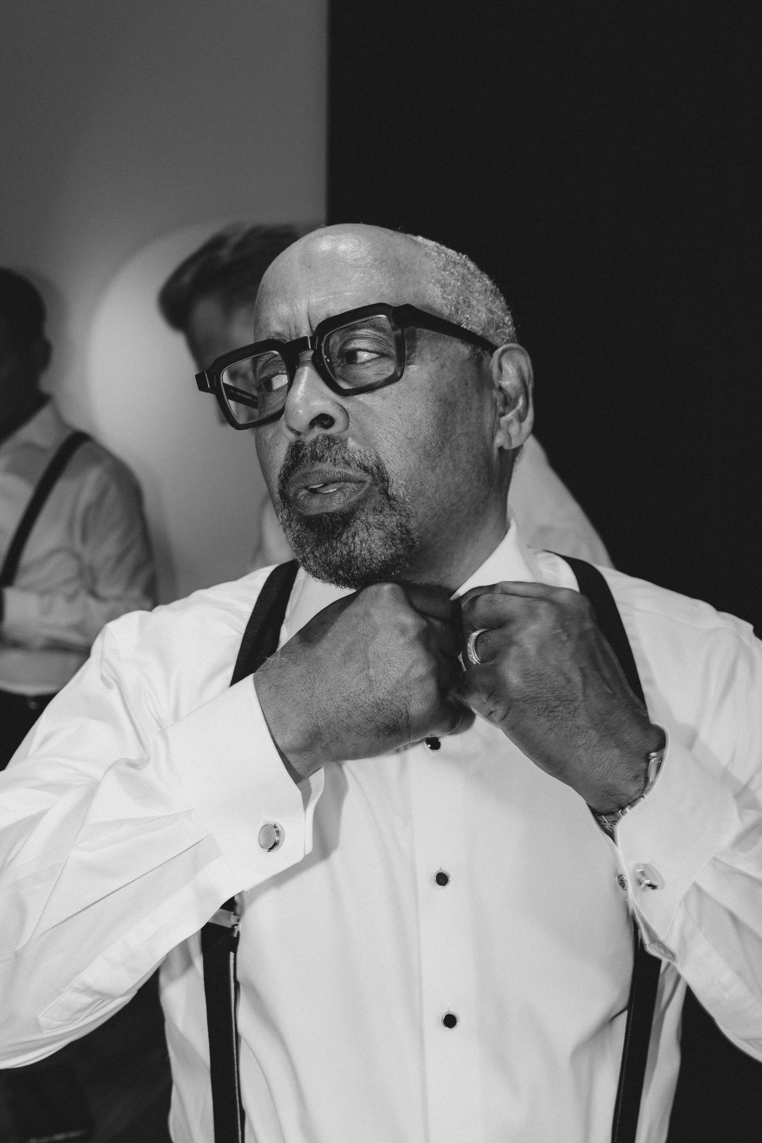 Black and white photo series showing a person in a white shirt and glasses smoking a cigar.