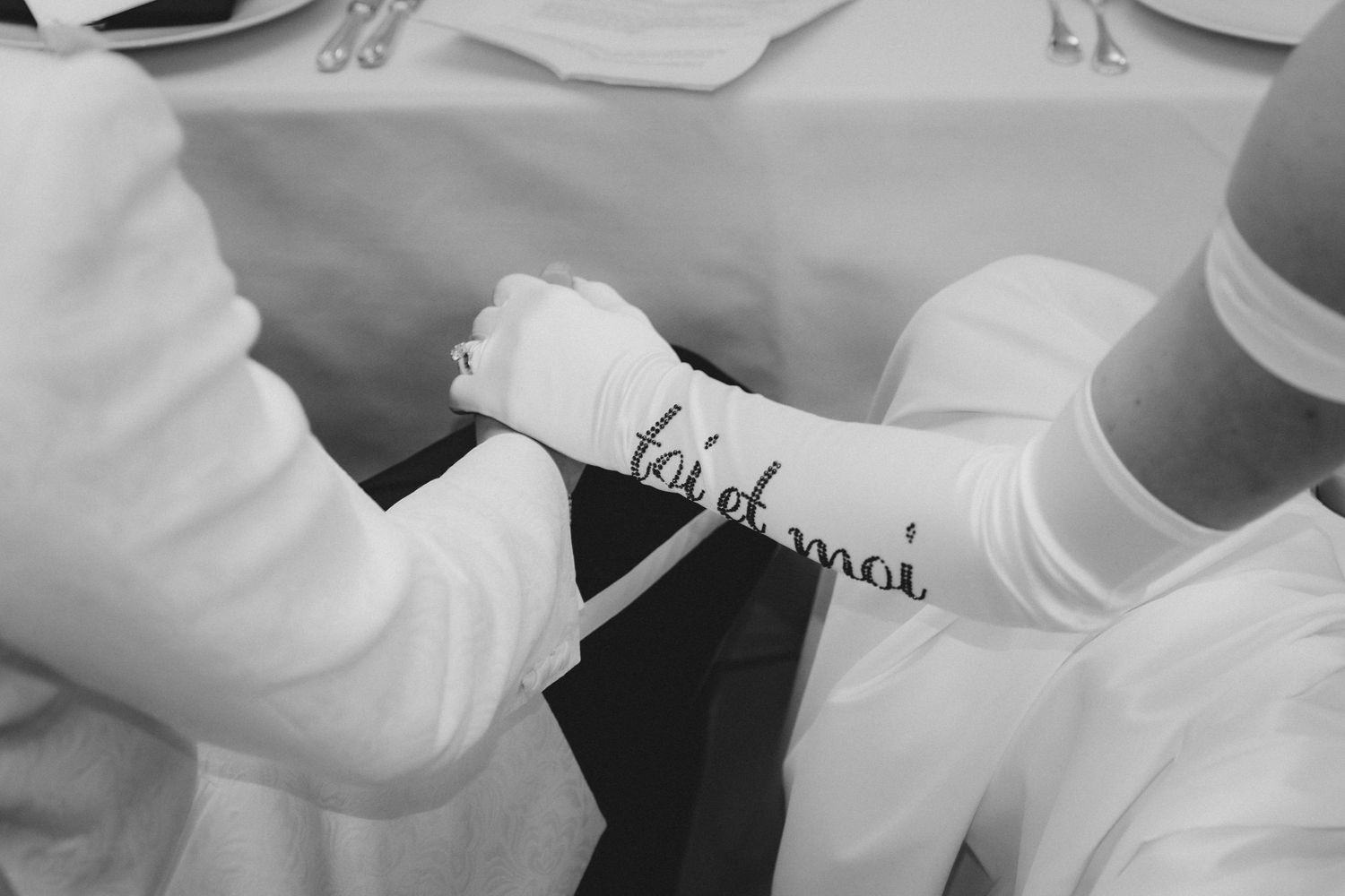 Chefs in white uniforms working together in a professional kitchen preparing food.