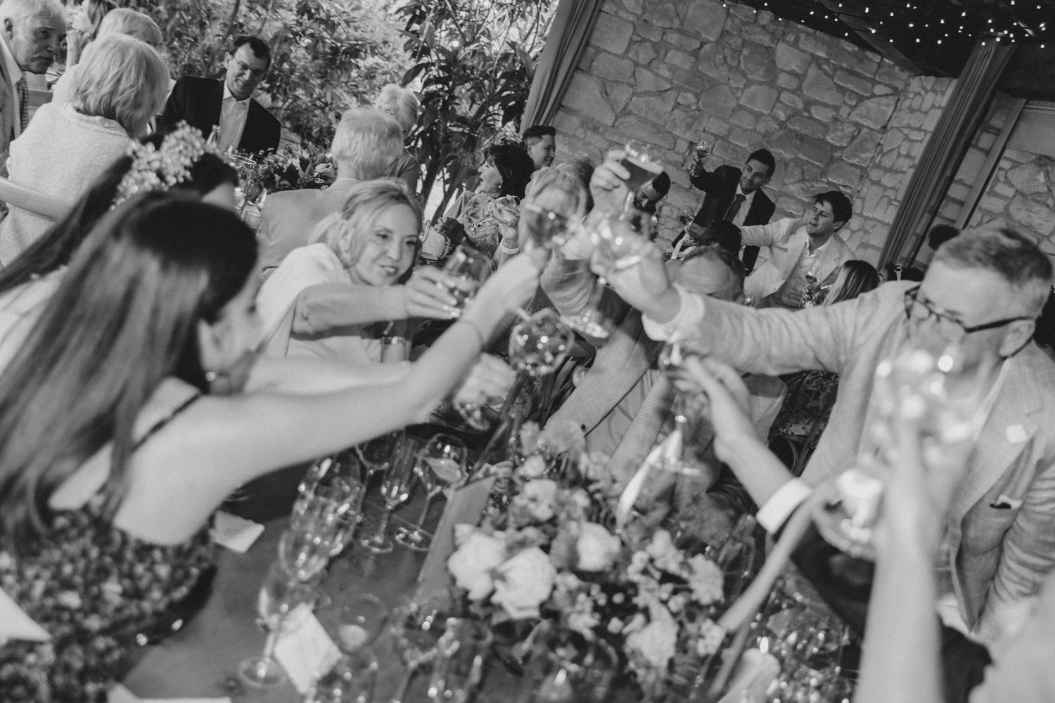 Black and white photo of wedding reception with dancing and celebration.