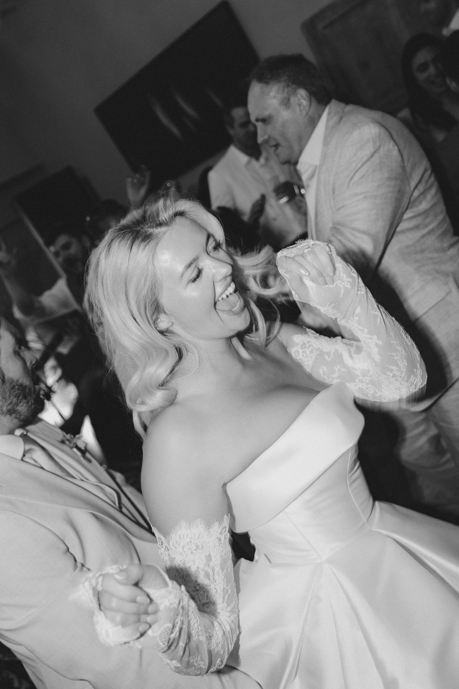 Wedding celebration dance floor moments captured in black and white photography.