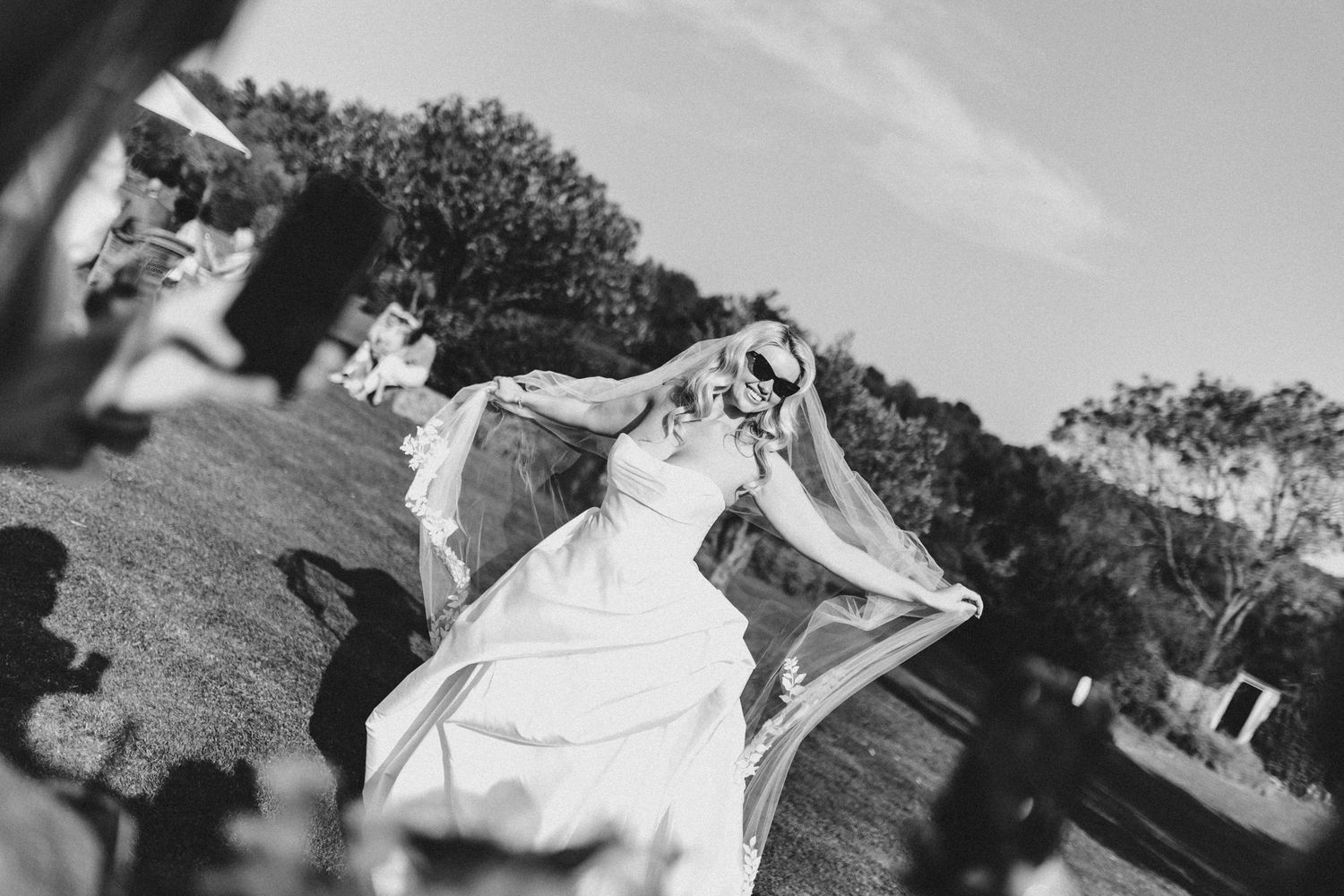 A collection of black and white wedding photographs showing outdoor celebrations and romantic moments between couples.