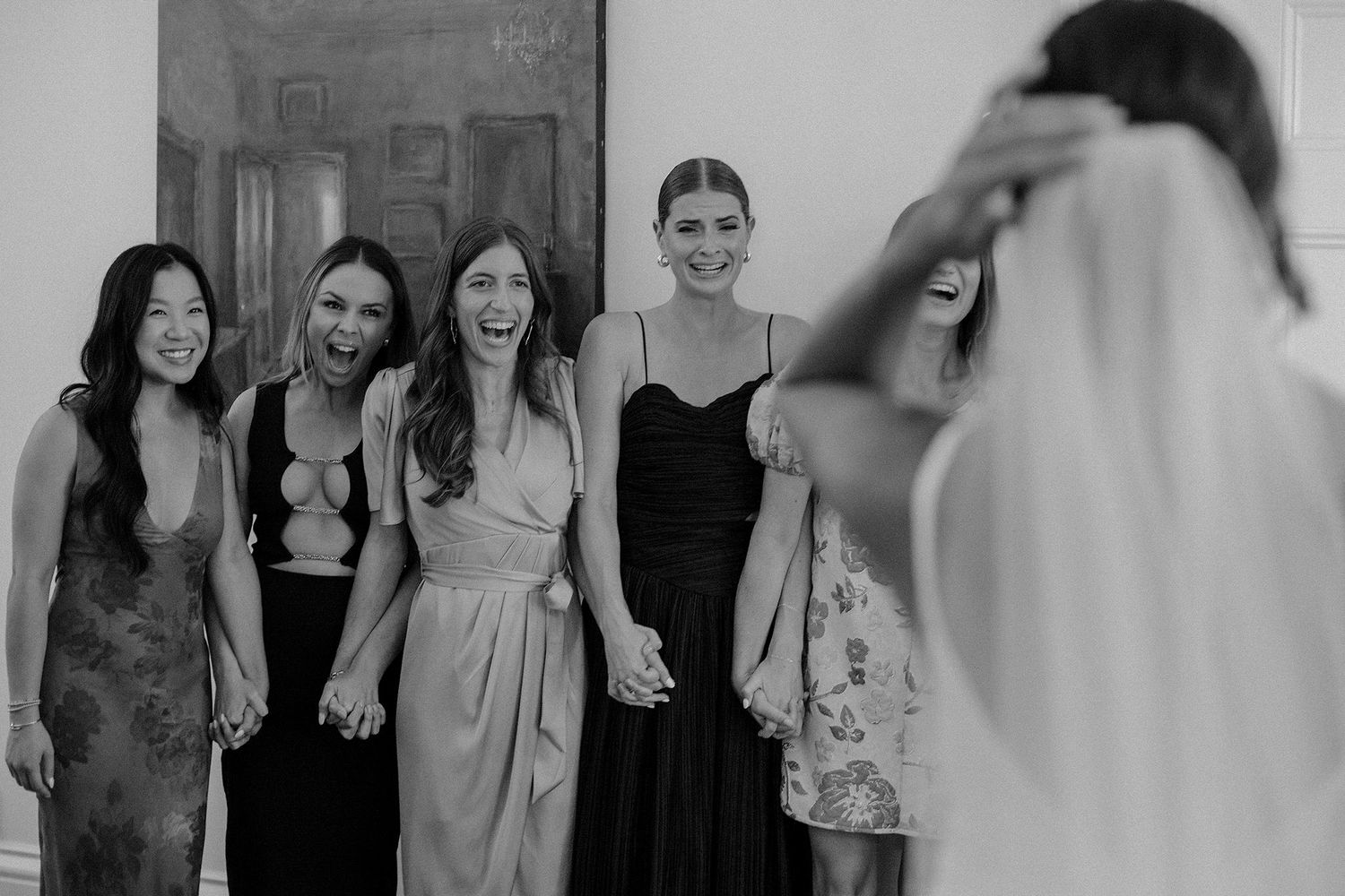 Excited bridal party seeing Bride for the first time.