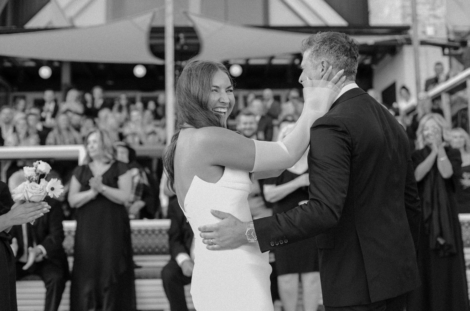 Beachfront Bride is overjoyed at her Muskoka wedding, gripping her groom after saying 