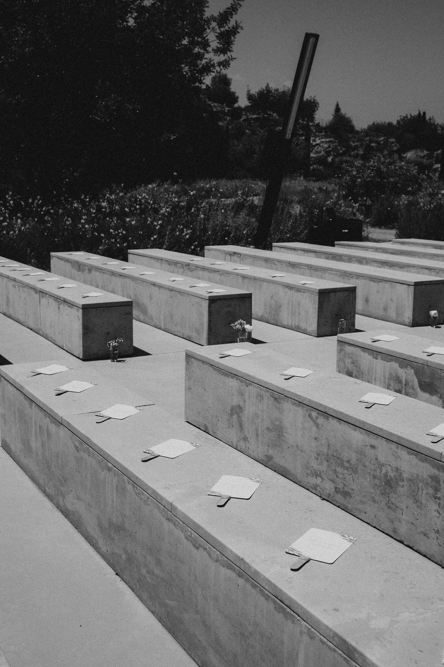 A black and white panoramic sequence showing a row of concrete memorial structures in a cemetery. Wedding in Les Moles.