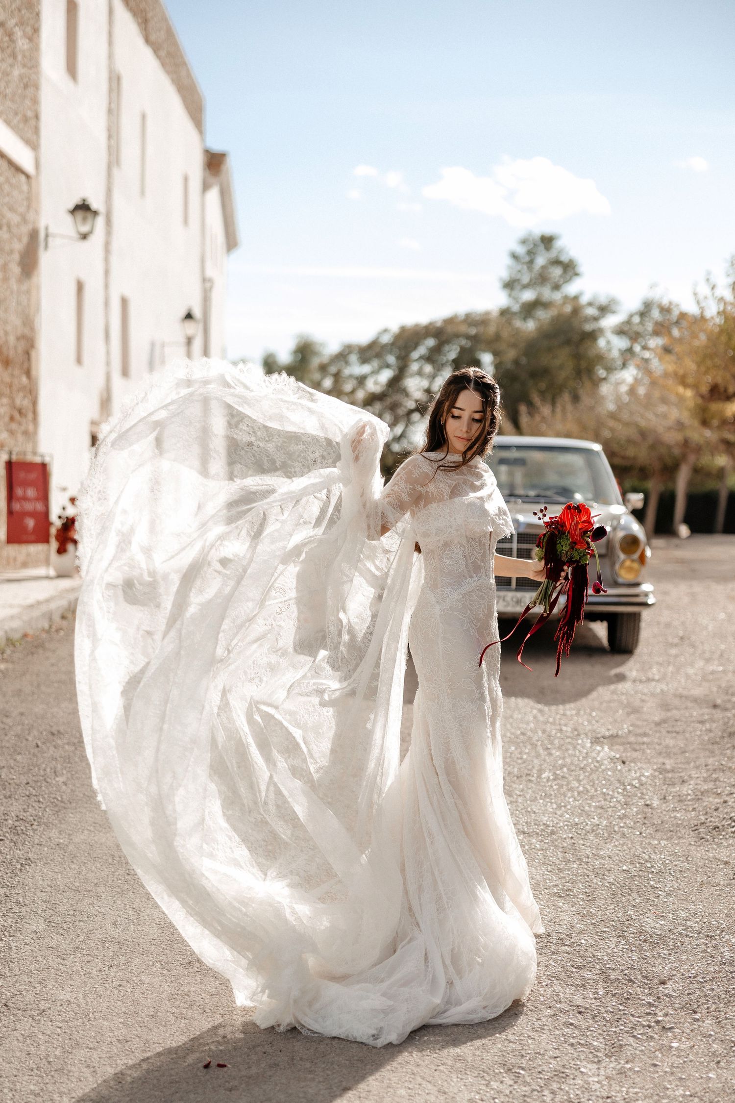 A flowing white wedding dress billows dramatically in the wind across a series of connected photographs. Wedding in Jardins del Tancat.