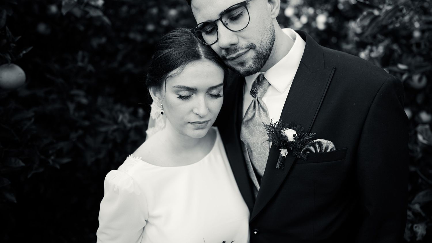 Intimate black and white wedding portrait showing tender moment between newlyweds. Wedding in Jardins del Tancat, Spain.