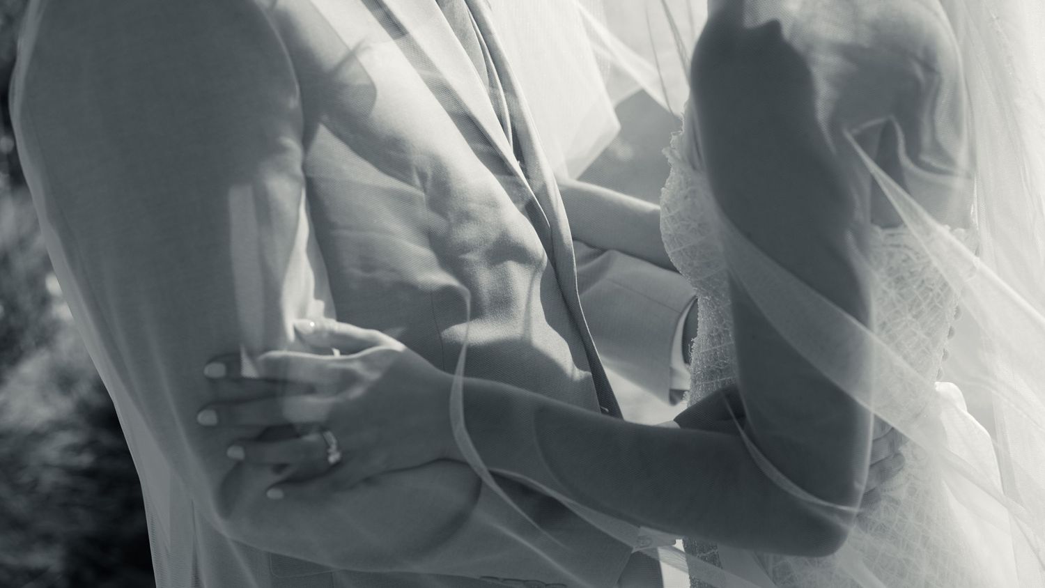 Artistic black and white detail shot of wedding attire with flowing fabric. Wedding in Les Moles, Spain.