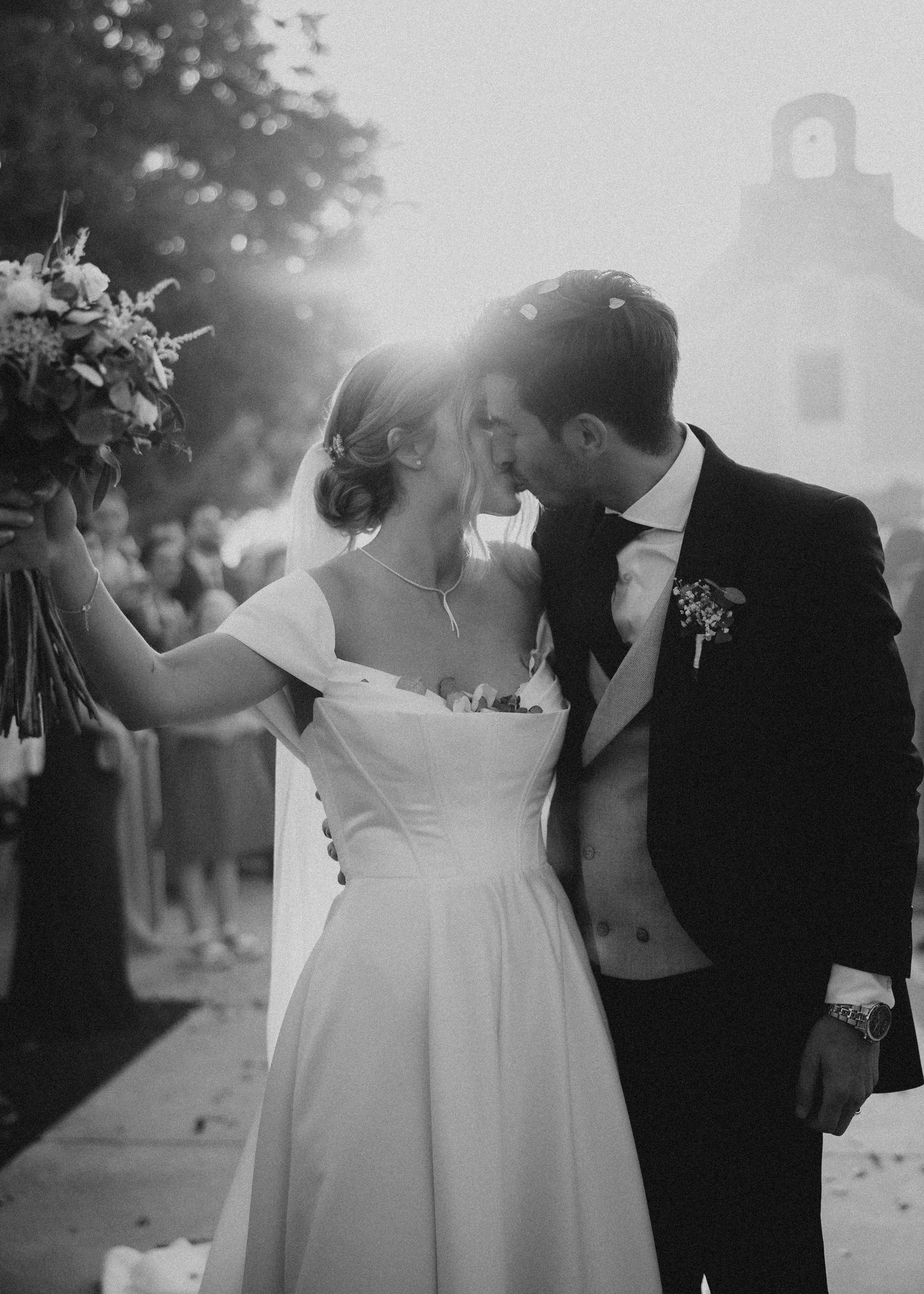 A romantic black and white wedding photo series showing a couple sharing intimate moments in outdoor settings. Masia Les Casotes.