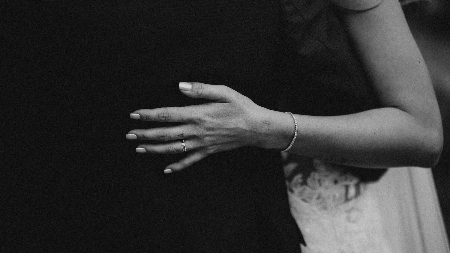 Black and white close-up of an elegant bracelet on a bride's wrist. Wedding in Les Moles, Spain.