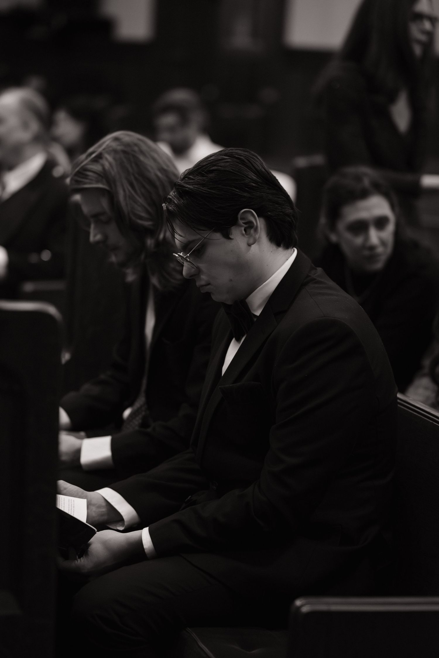Black and white photo of a pianist performing at a formal concert.