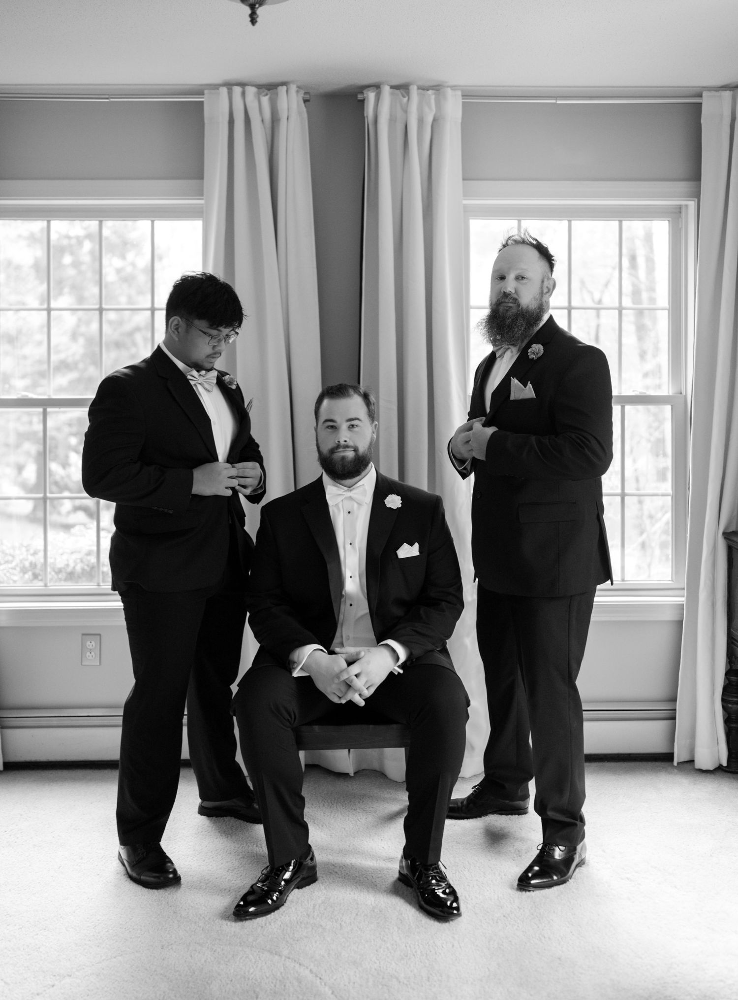 Black and white series showing men's dress shoes and formal attire details at a wedding.