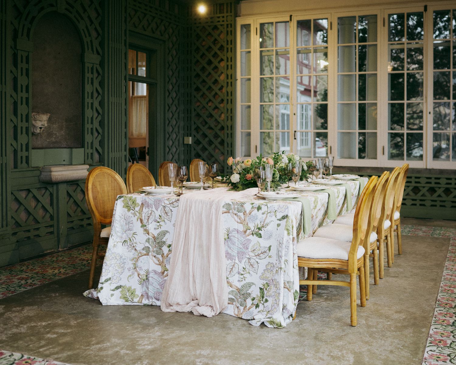 Elegant wedding reception venue with gold chairs and floral table settings.