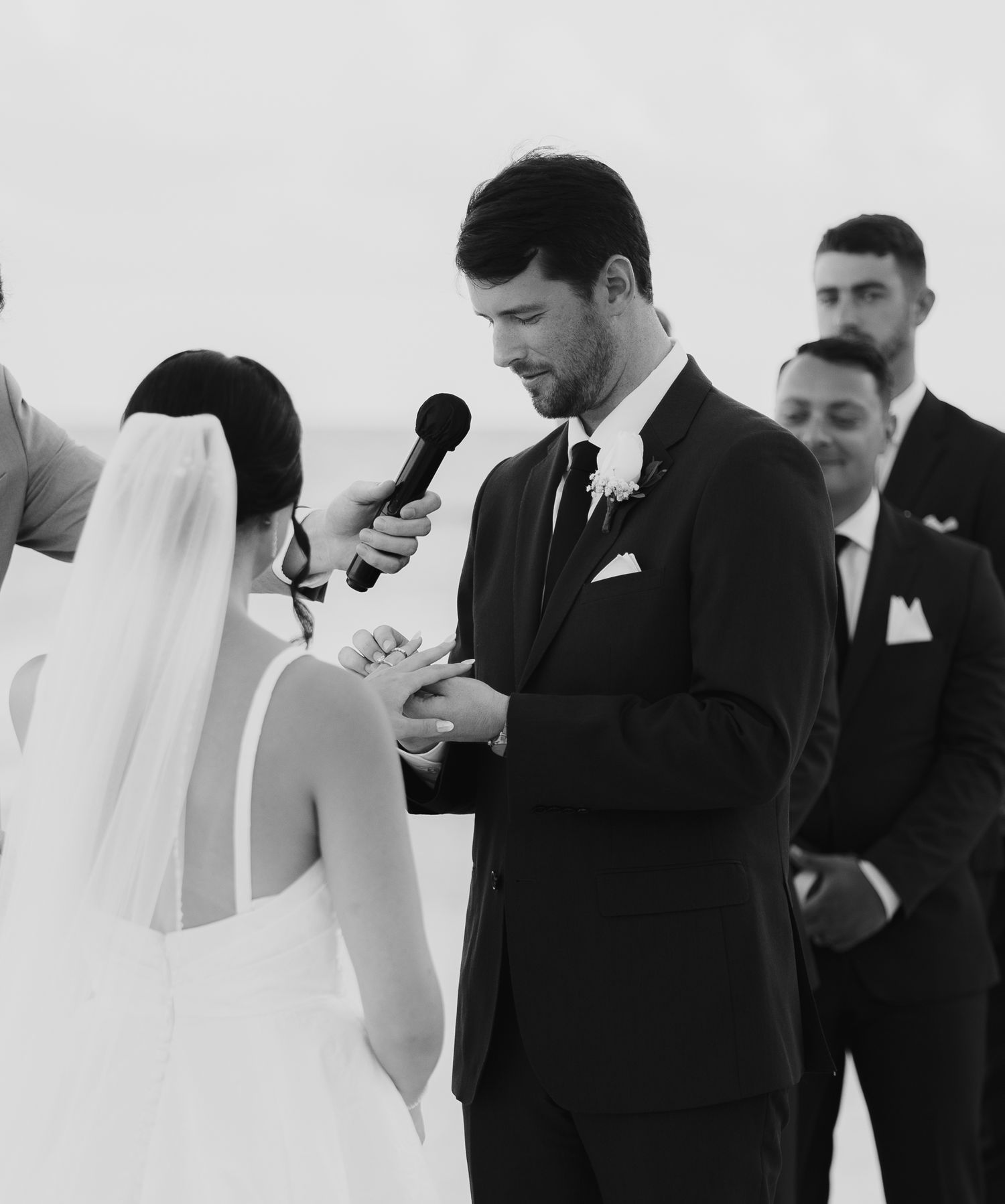 A wedding ceremony in progress with exchange of vows in black and white.
