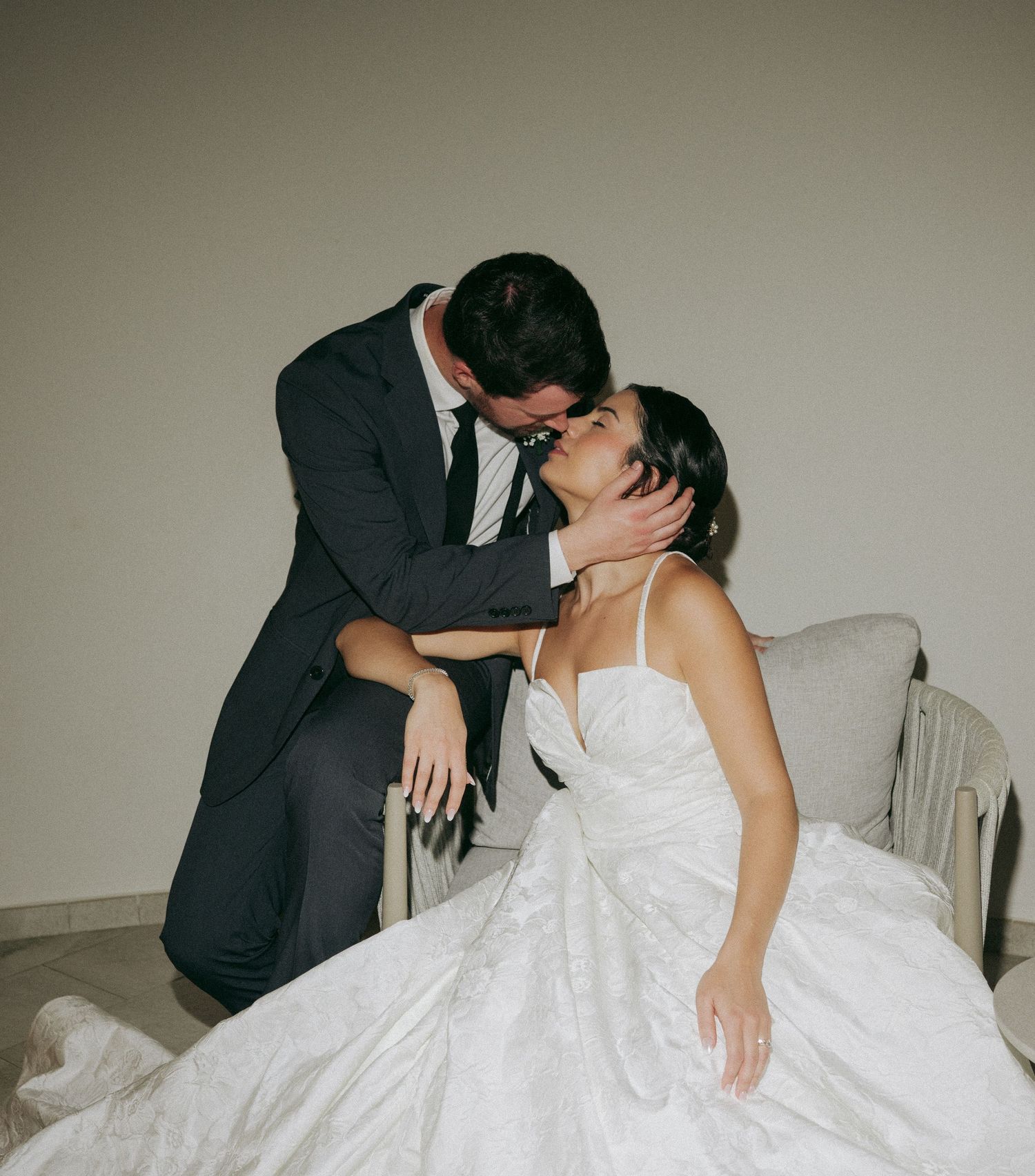 A romantic sequence of wedding photos showing a couple in formal attire sharing intimate kisses against a neutral background.