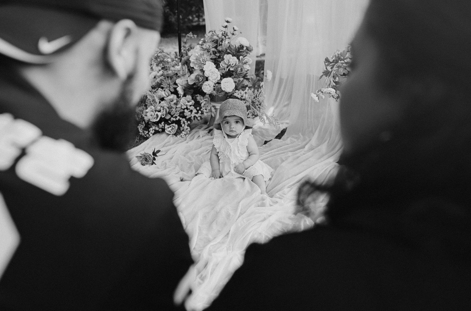 Artistic black and white detail shot of wedding flowers and veil.