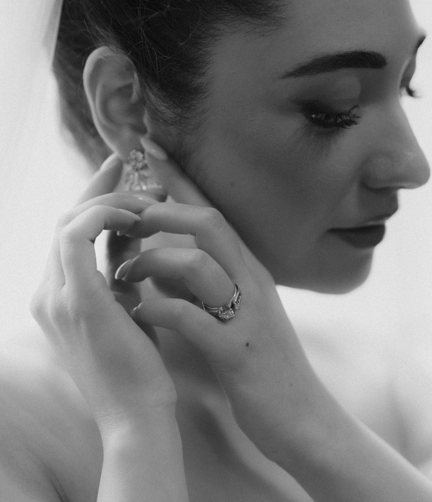 A series of black and white profile portraits showing elegant poses with delicate hand gestures.