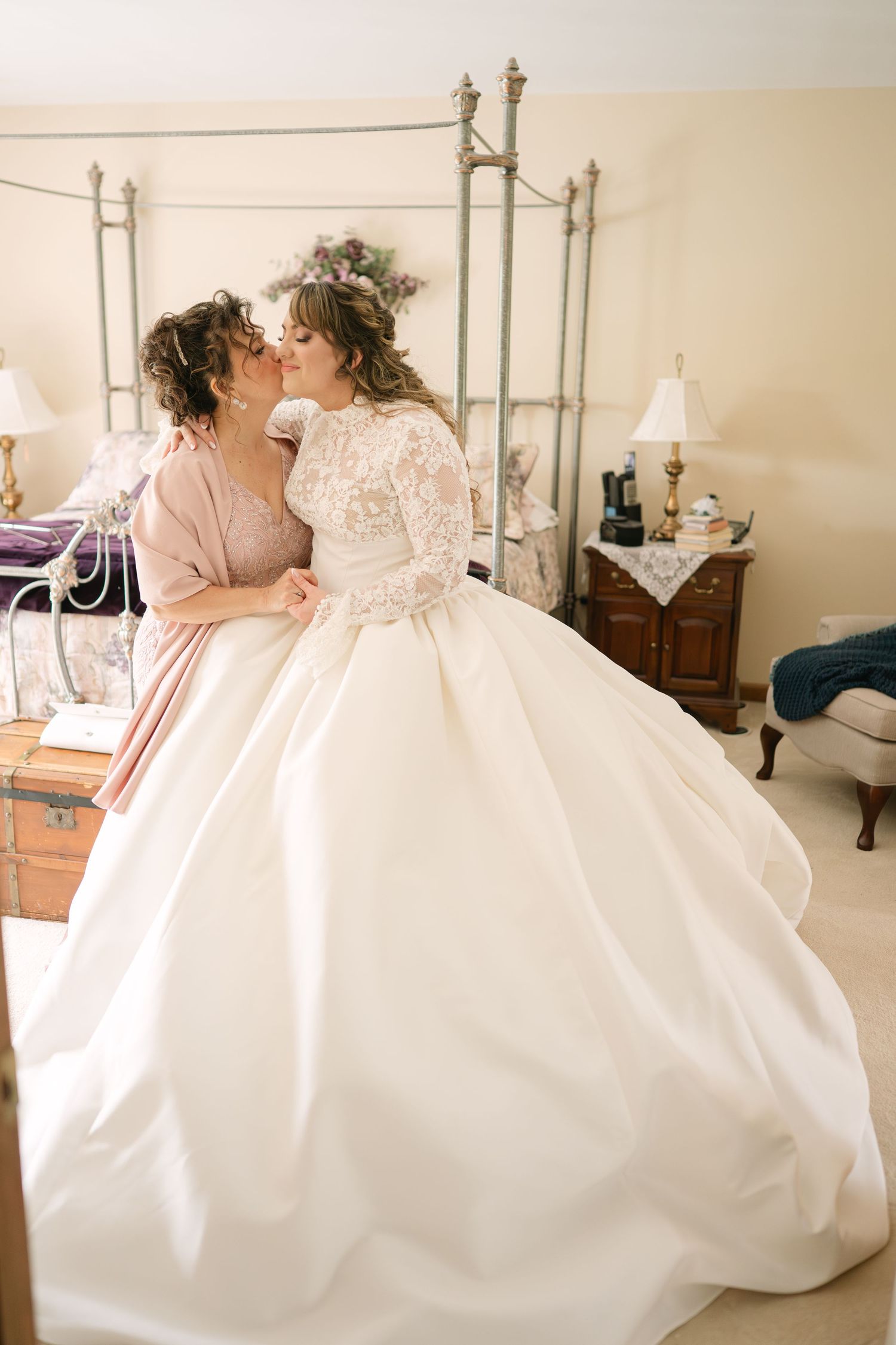 Romantic couple in wedding attire share intimate moments in an elegant room with vintage furniture and decor.