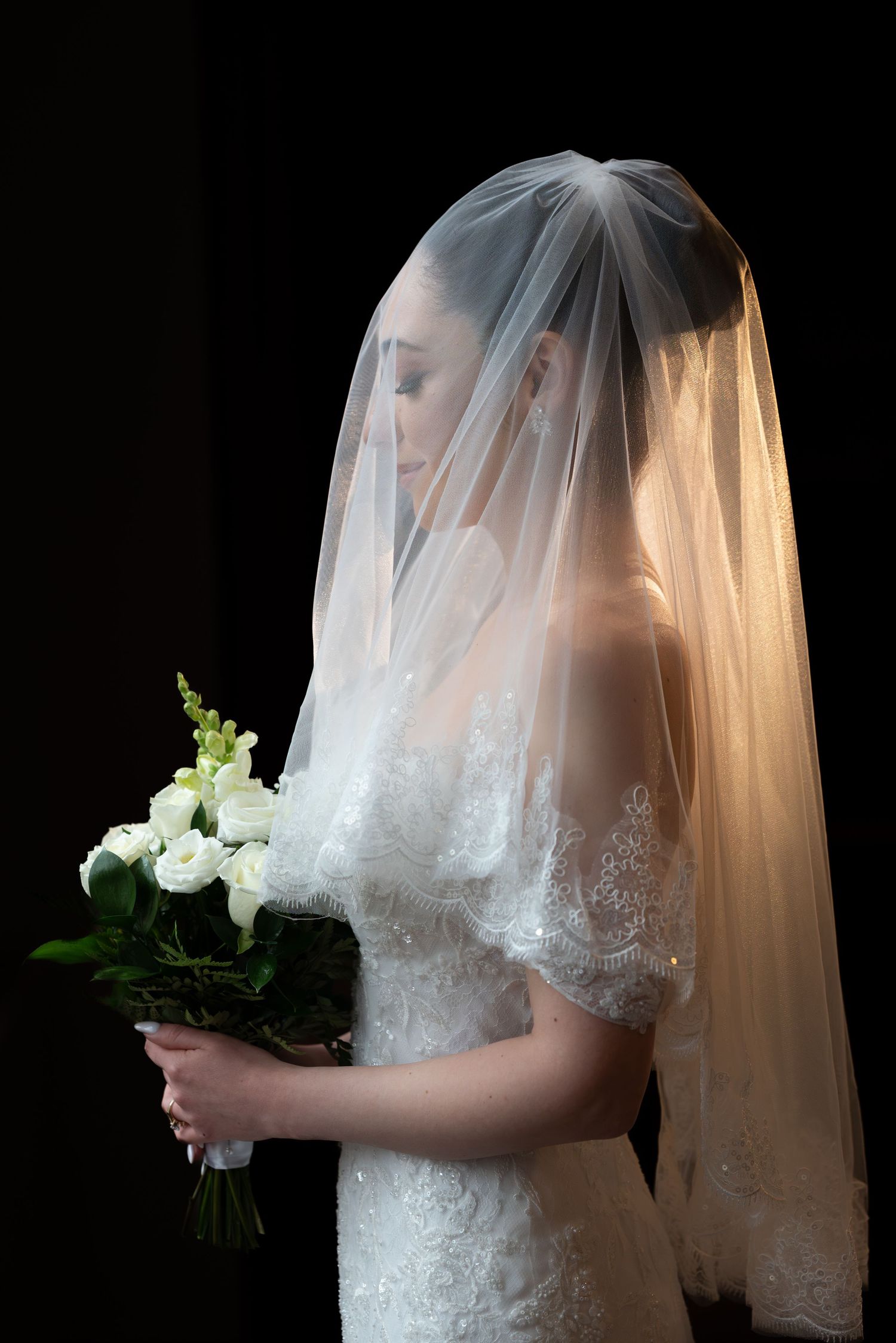 A series of artistic bridal portraits showing a delicate white veil and bouquet against a dark background.