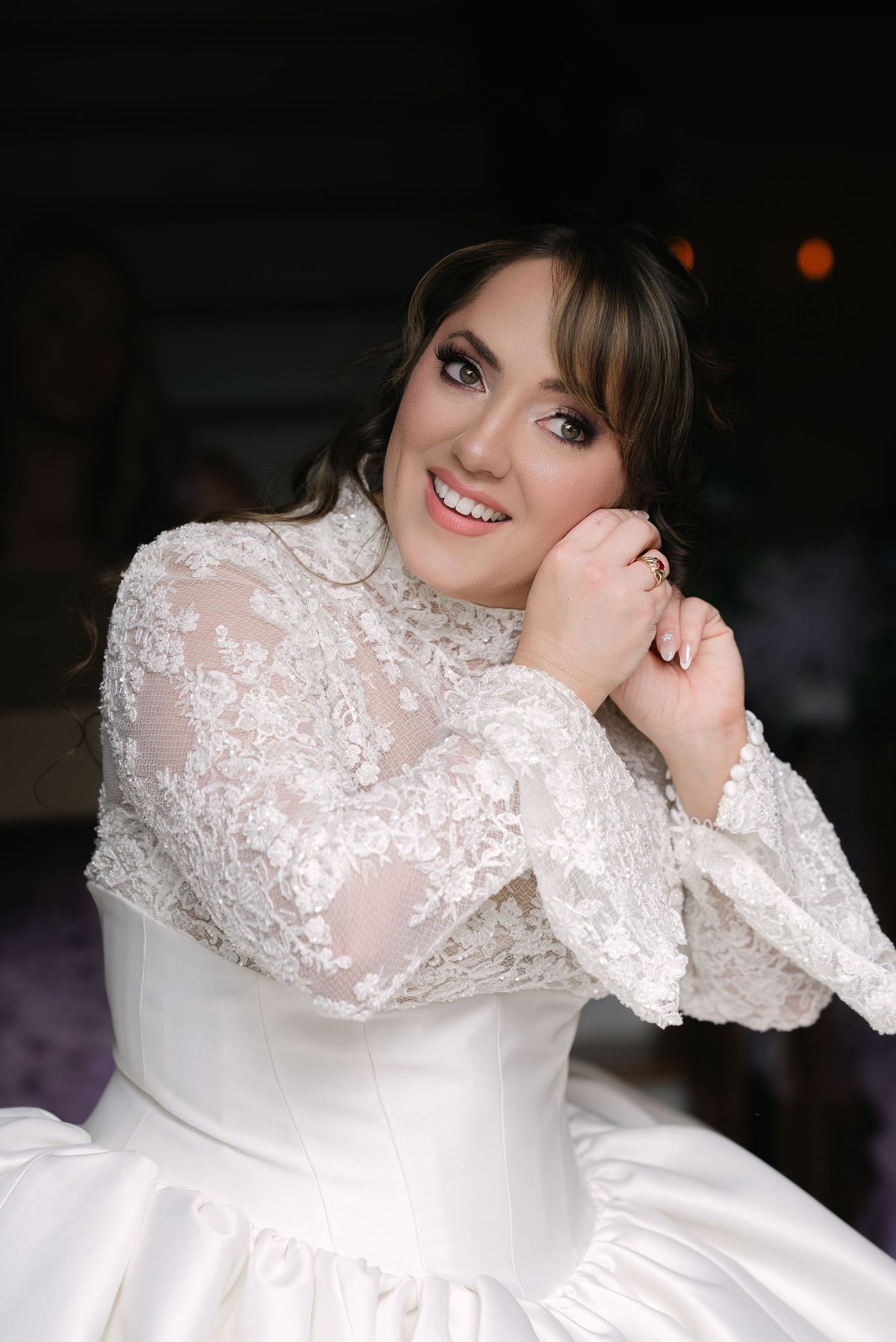 A close-up view of intricate white lace details on a wedding dress.