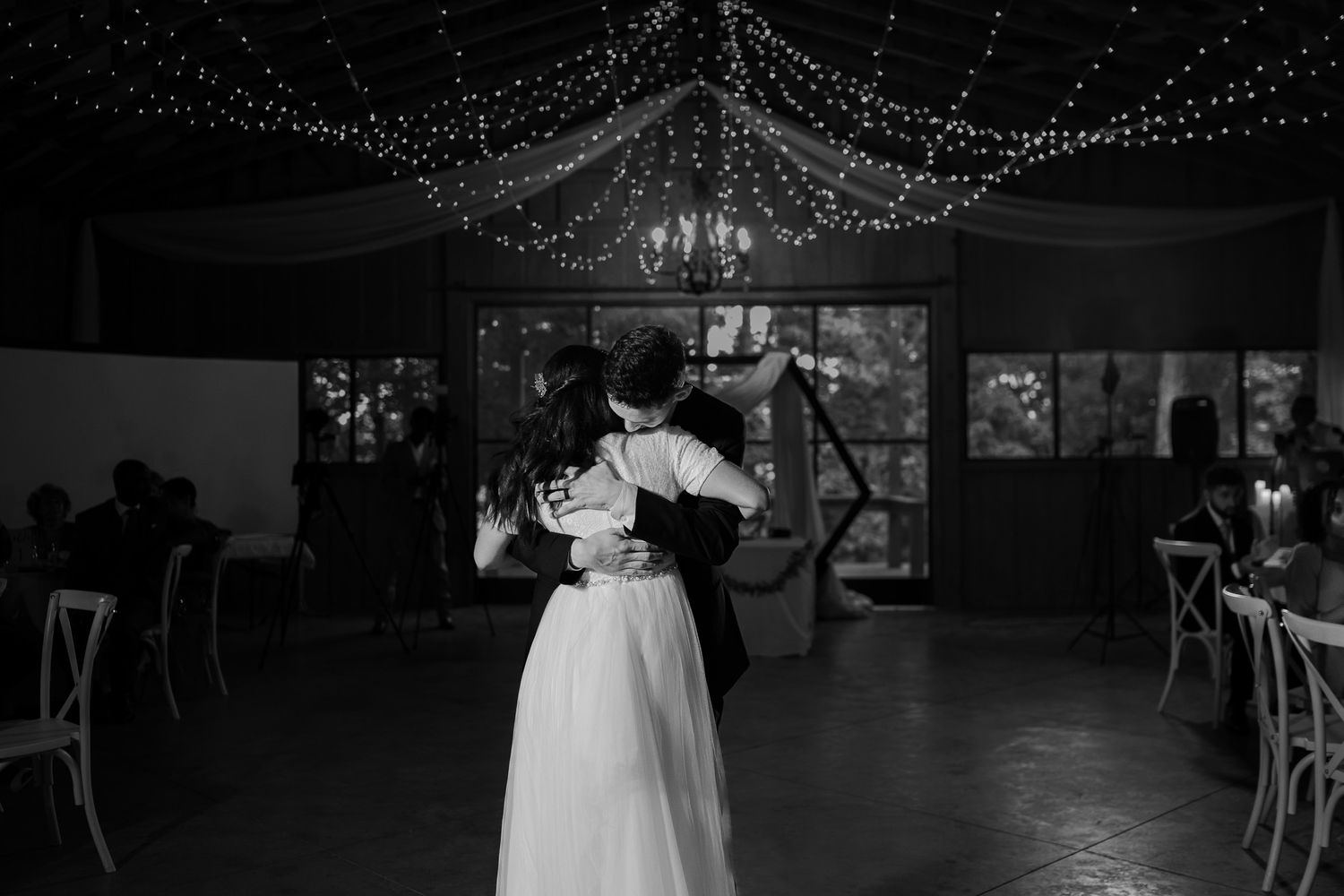 Wedding reception venue with twinkling lights creating a magical atmosphere on the dance floor.