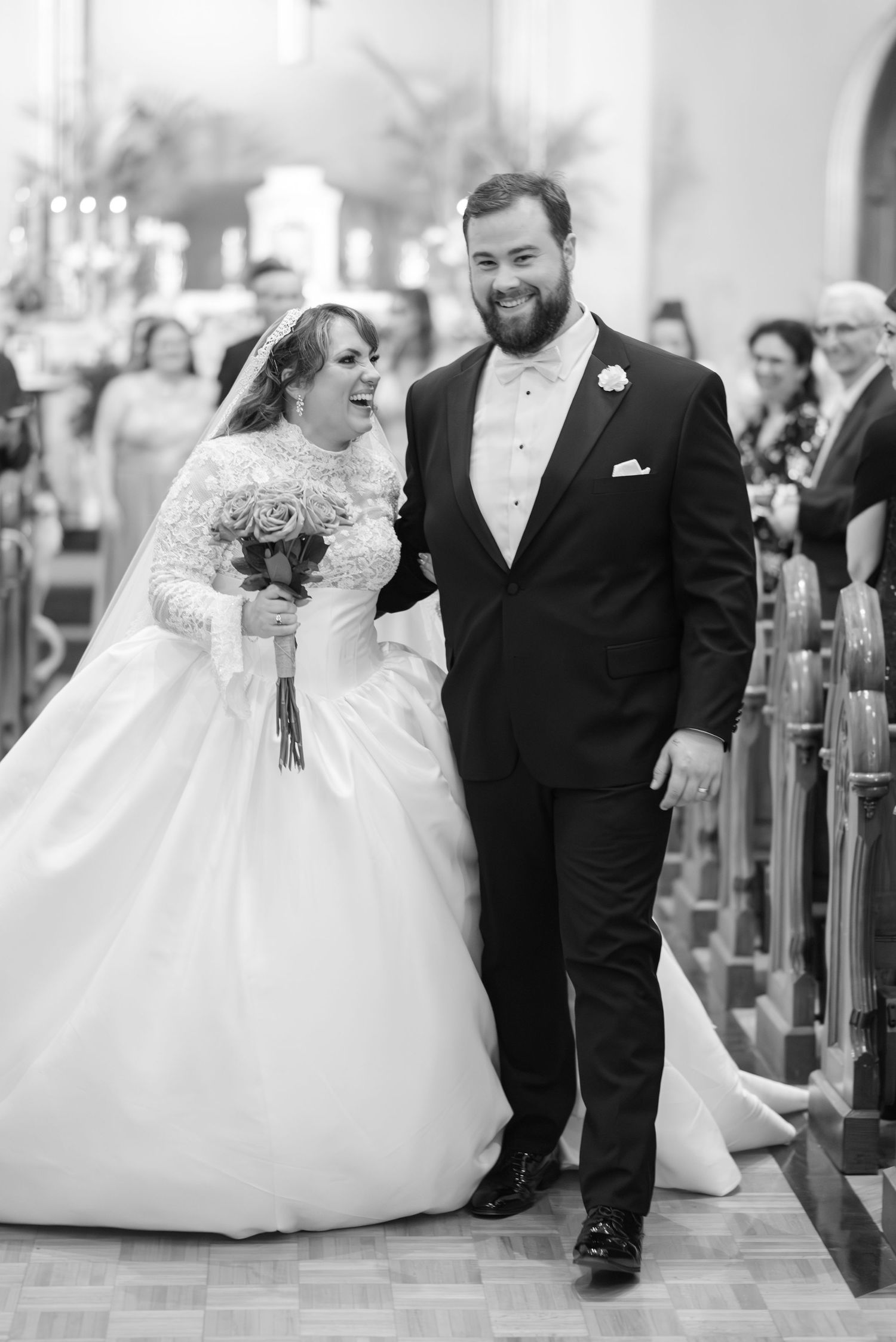 A wedding ceremony in a church with elegant decor and traditional formal attire.