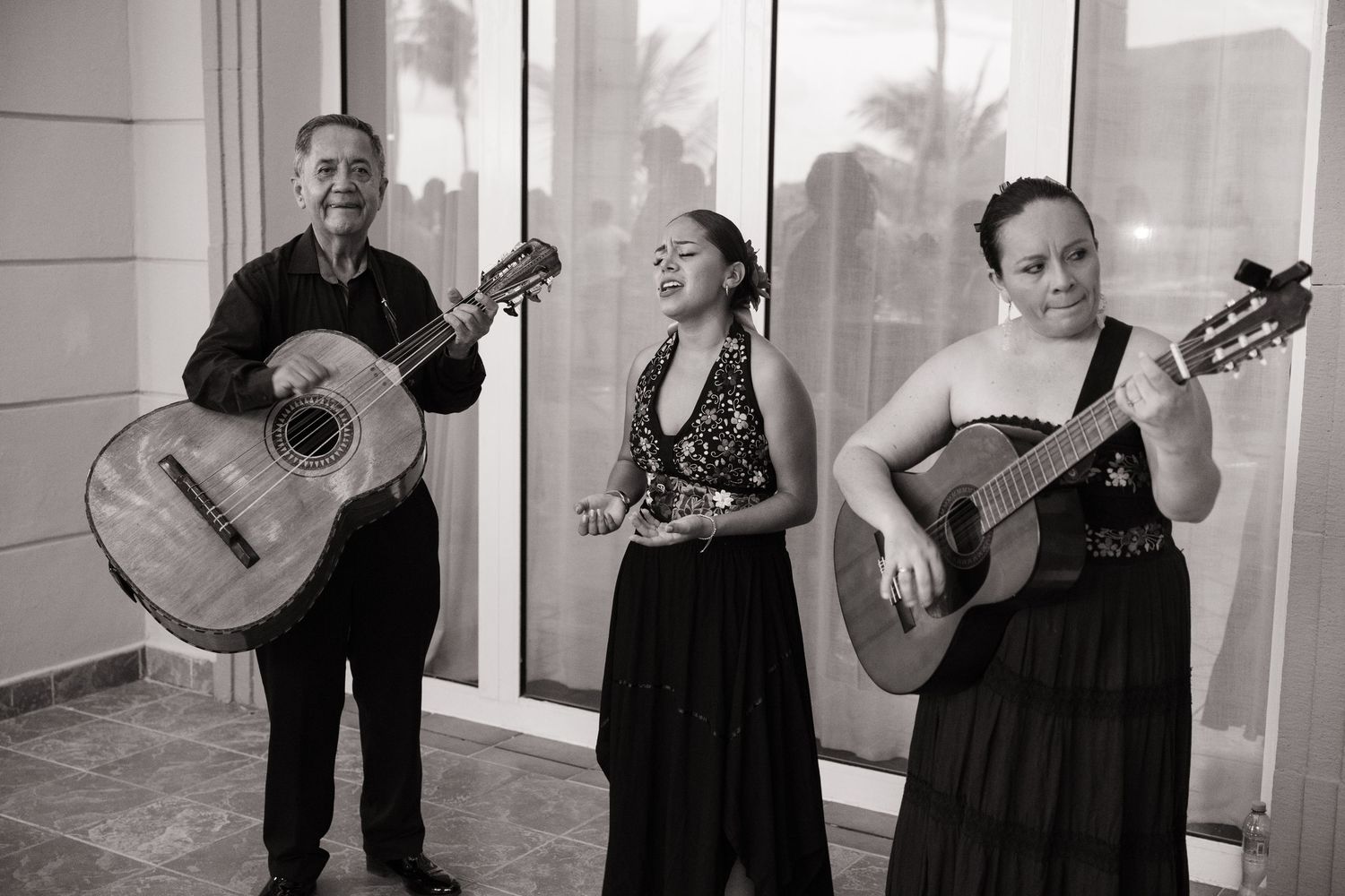 A series of black and white photographs showing a person playing an acoustic guitar in various poses.