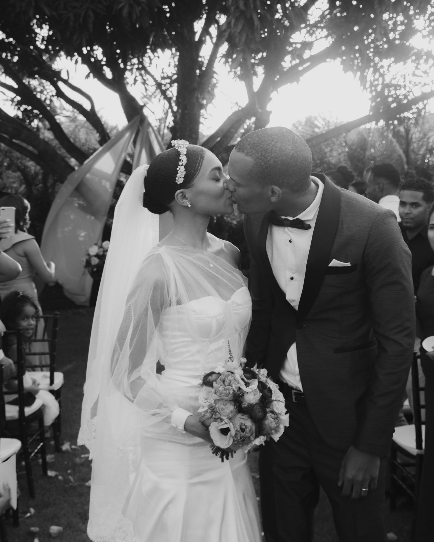 Joyful wedding celebration moments captured in black and white outdoors.
