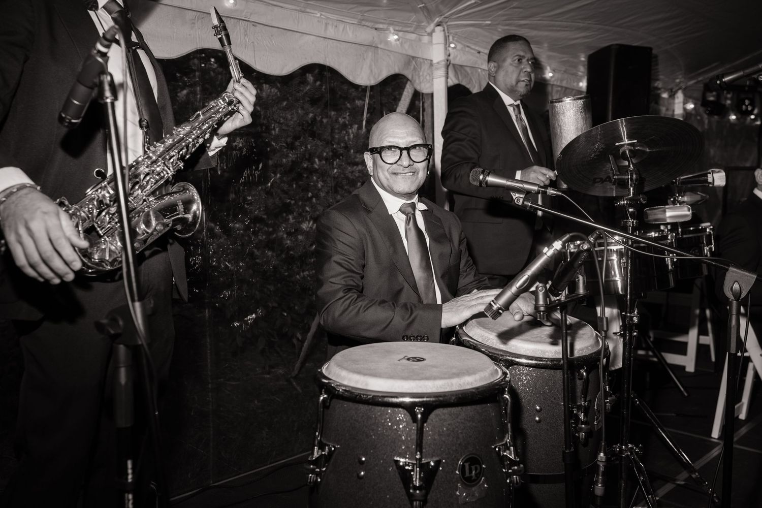 Black and white photo of a live band performing at a wedding reception.
