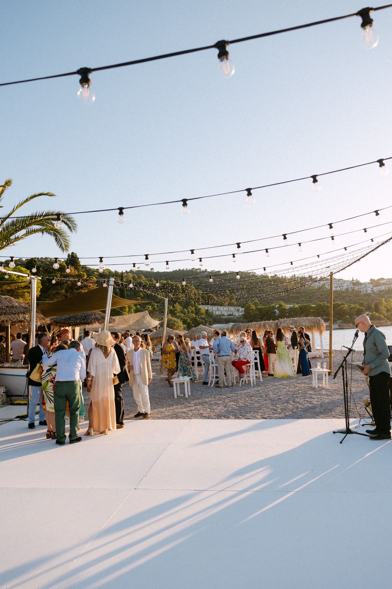 guests during cocktail hour at a beach bar