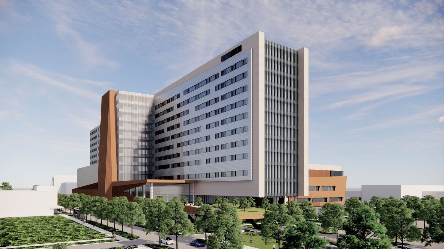 Modern multi-story hospital building exterior with white facade, copper accents, and landscaped grounds under blue sky.