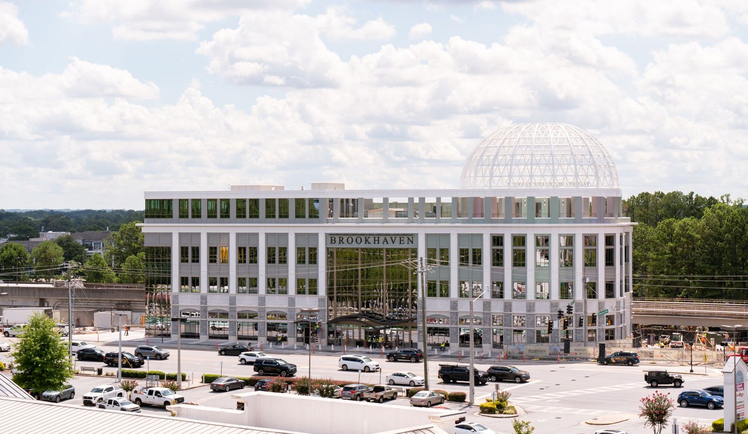 Aerial panoramic view of a large corporate office building complex with parking lots and surrounding landscape.