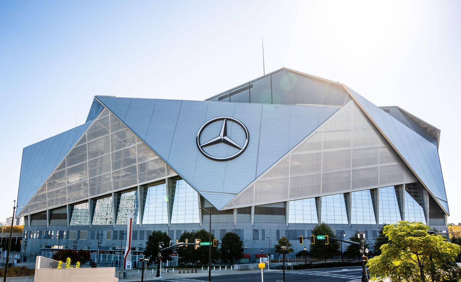 The iconic Mercedes-Benz Stadium in Atlanta features a distinctive angular roof design with glass panels and metal framework.