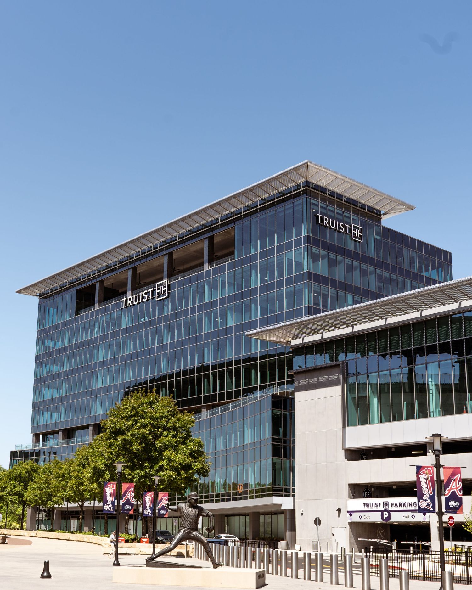 Modern office buildings with glass facades and concrete architecture shown in a panoramic view on a sunny day.