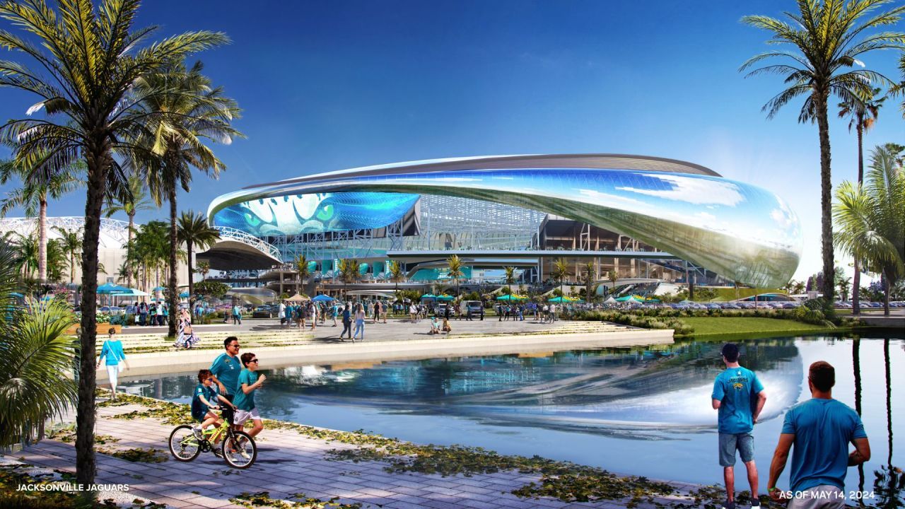 Futuristic stadium rendering with sleek curved architecture, palm trees, waterfront plaza, and visitors enjoying the outdoor space.