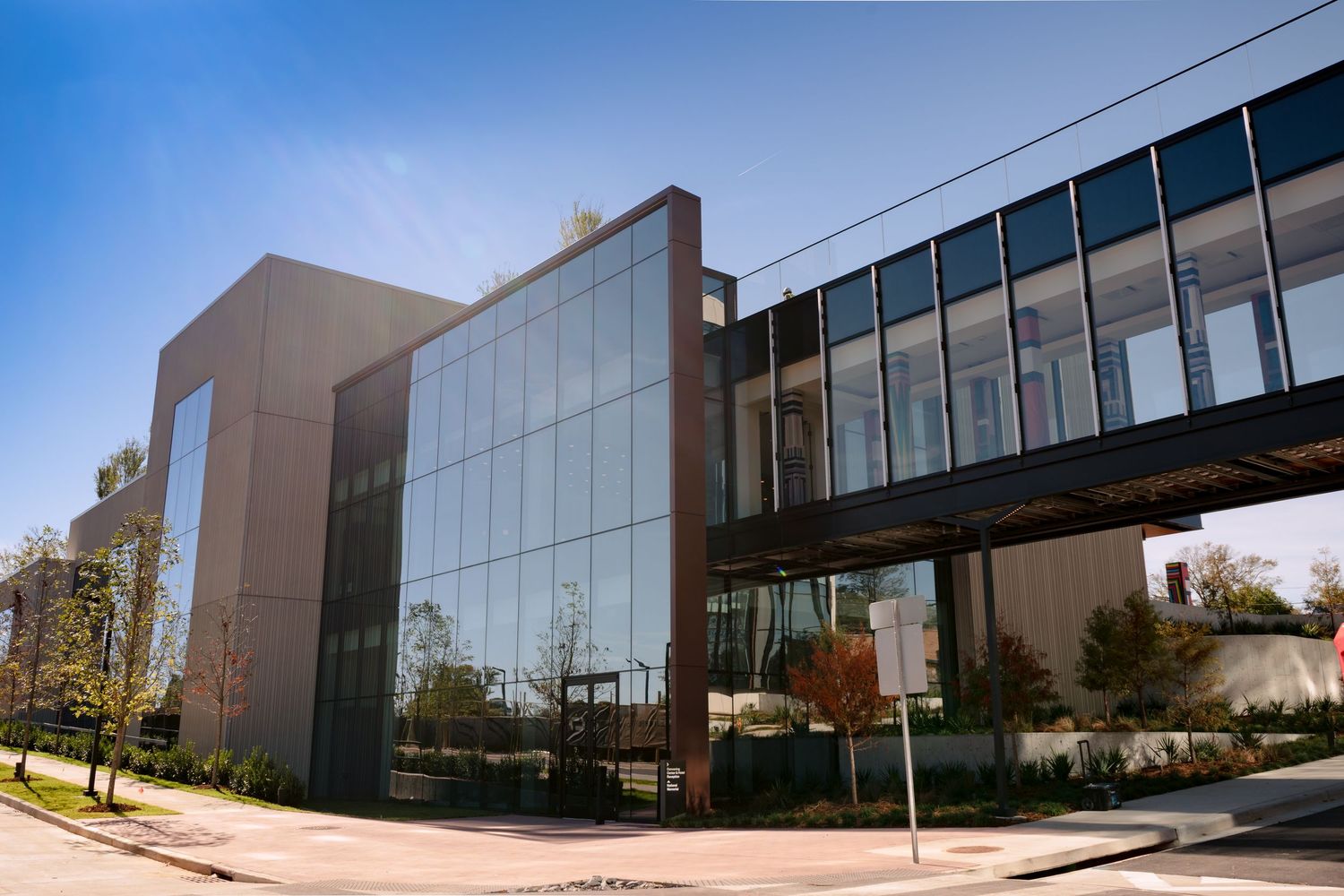 Modern office building exterior with glass windows and metal facade shown from multiple angles in daylight.