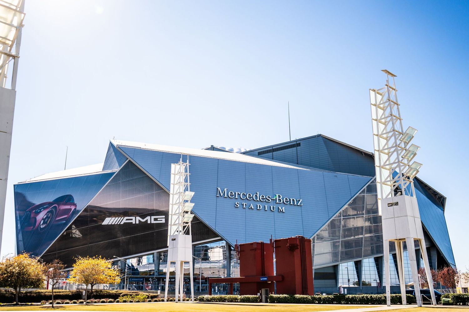 Modern industrial buildings with metal siding and angular architectural features against a bright blue sky.