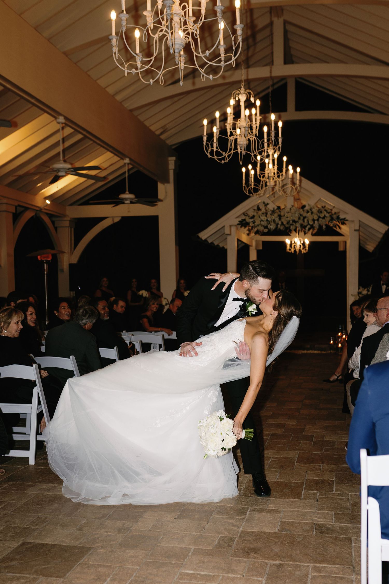 Sequence of wedding dance dip photos showing couple performing dramatic moves under elegant chandeliers.