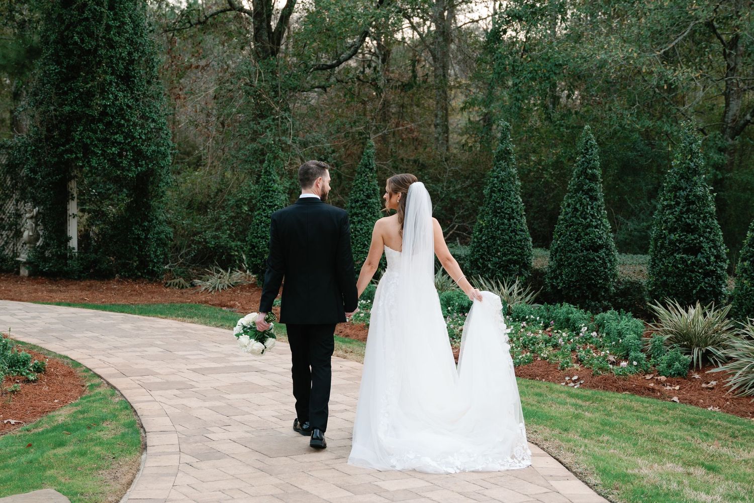 A sequence of wedding photos showing people walking through a lush garden path during an outdoor ceremony.