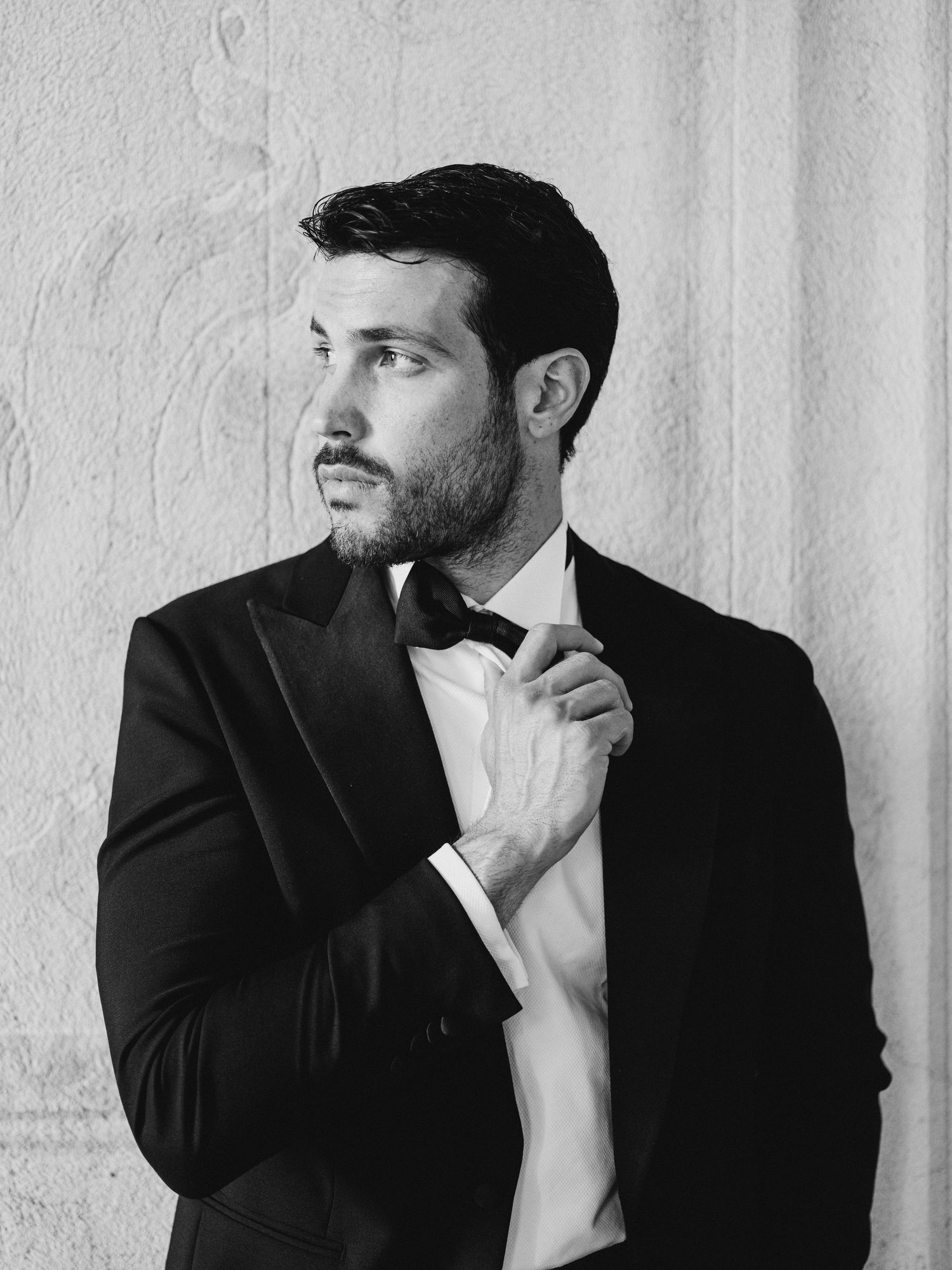 Artistic black and white portrait series in a minimalist white setting.