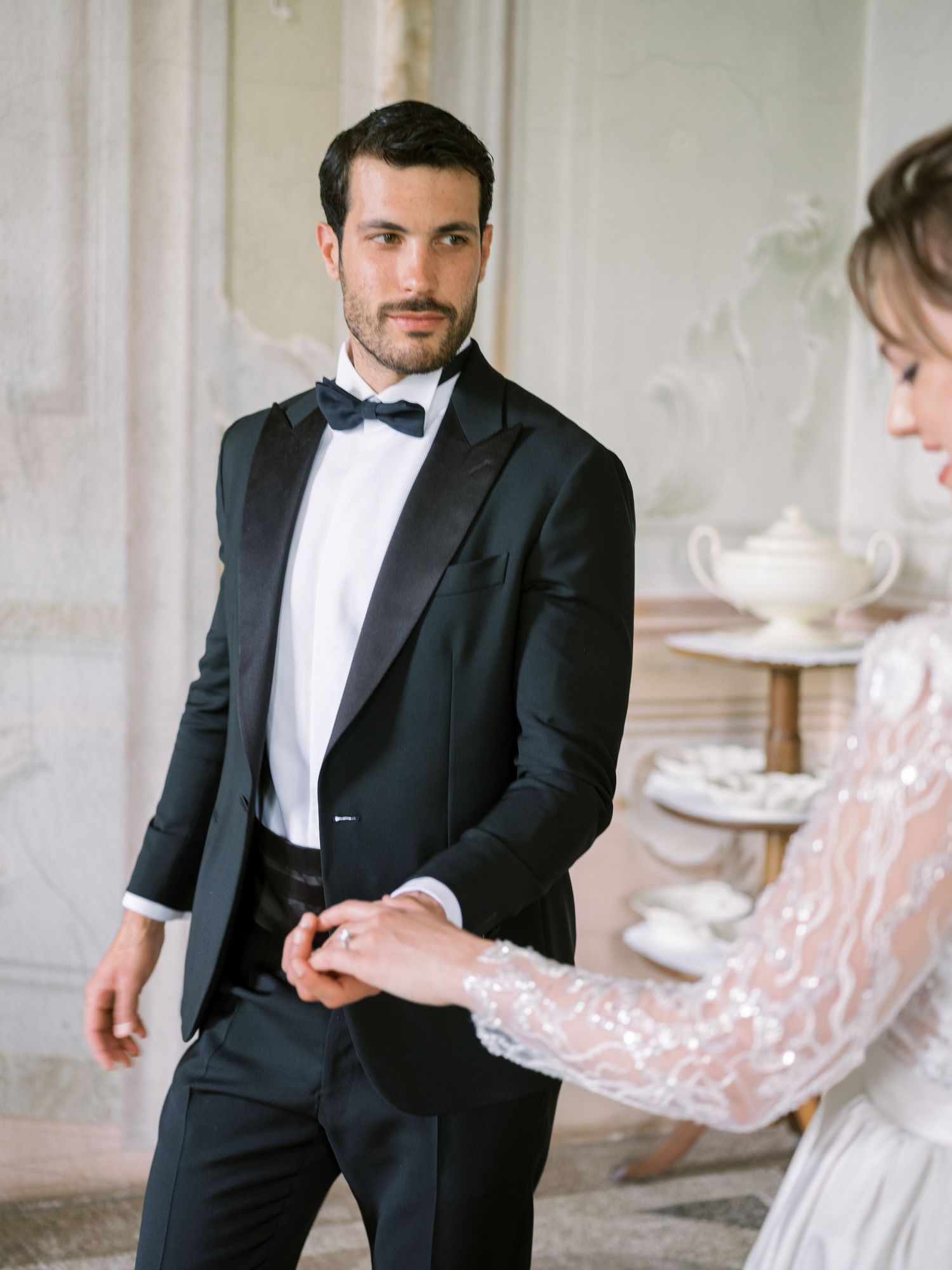 Romantic wedding photography sequence in an elegant white room with classical details.