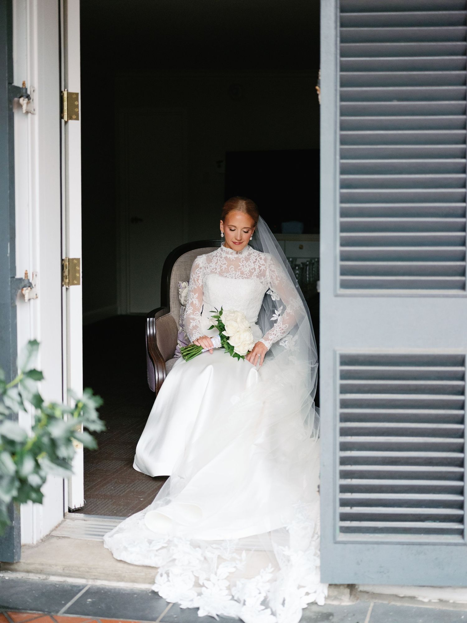 Wedding dress details captured through doorways with gray shutters.