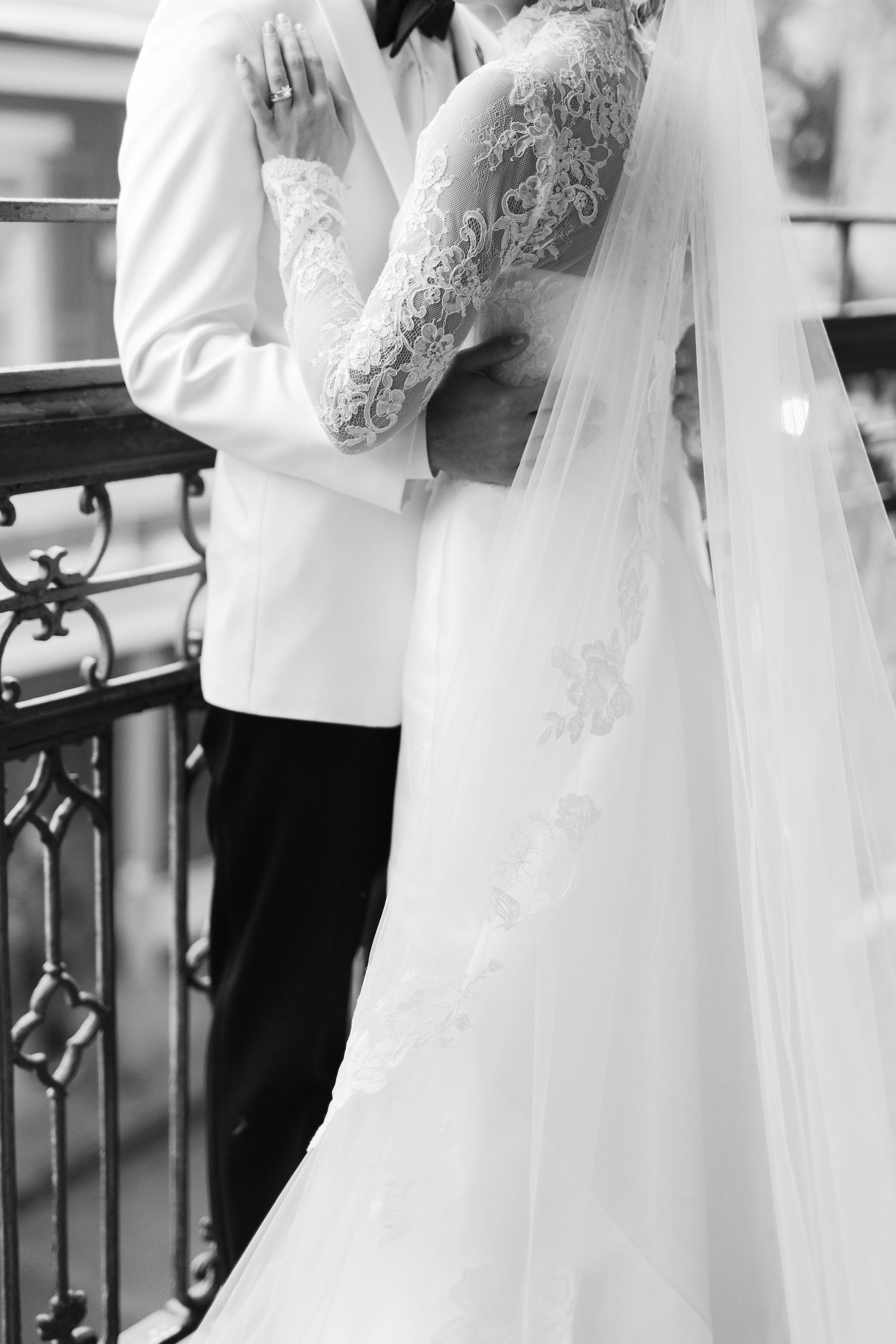 Wedding couple in white formal attire sharing intimate moment in church.