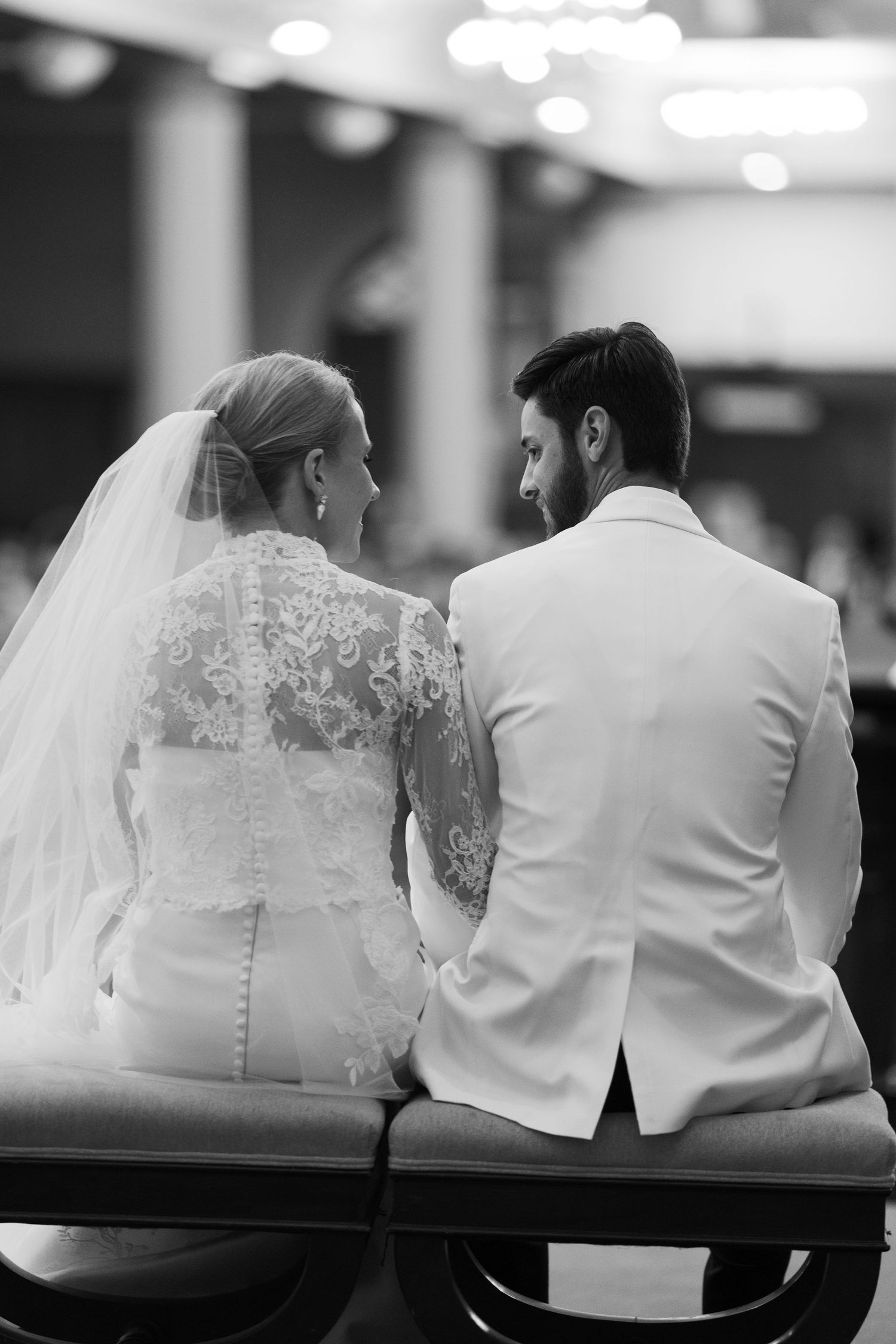 Black and white series of wedding couple sitting together in elegant formal attire.