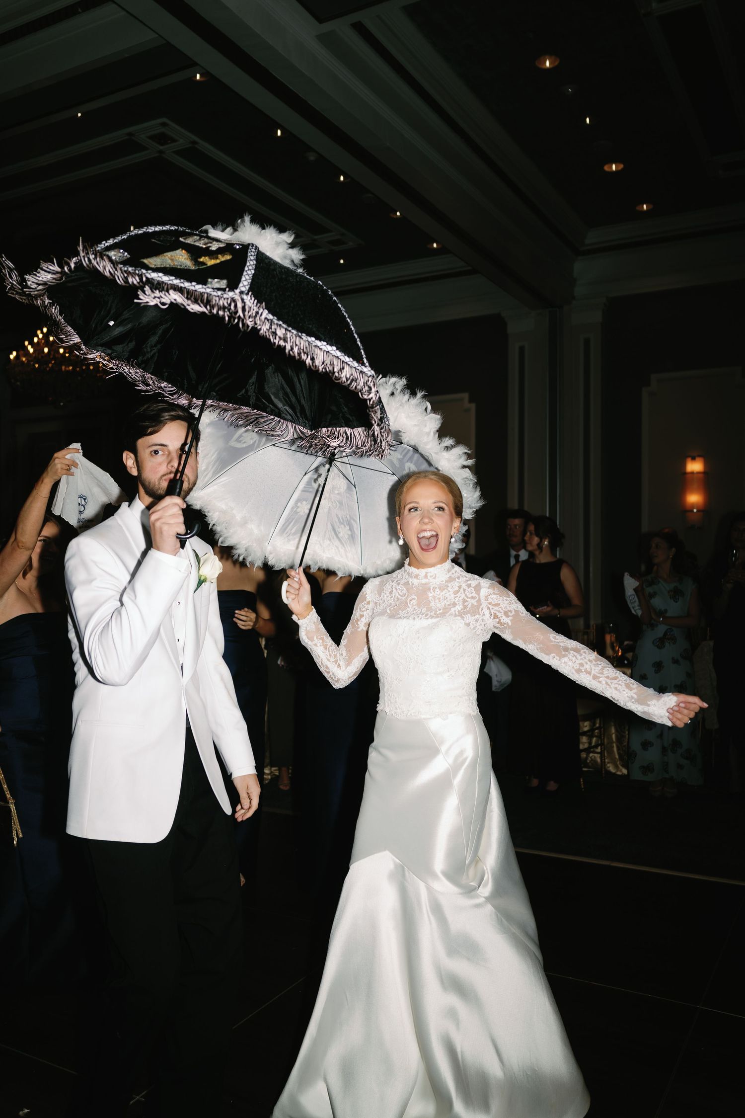 Wedding reception dance party with white decorations and festive lighting.