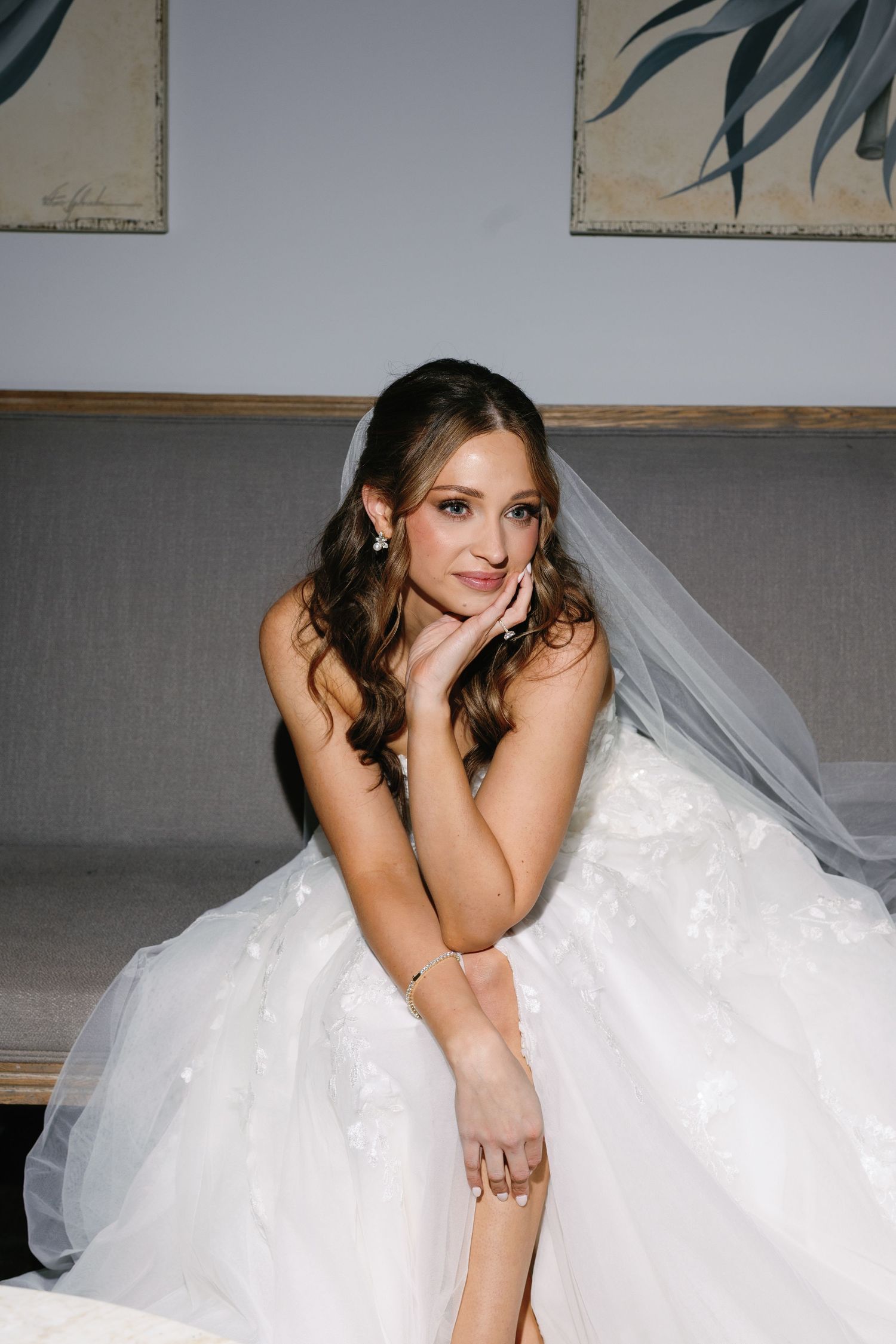 A series of artistic bridal portraits showing a bride in a flowing white gown and veil against a gray backdrop.