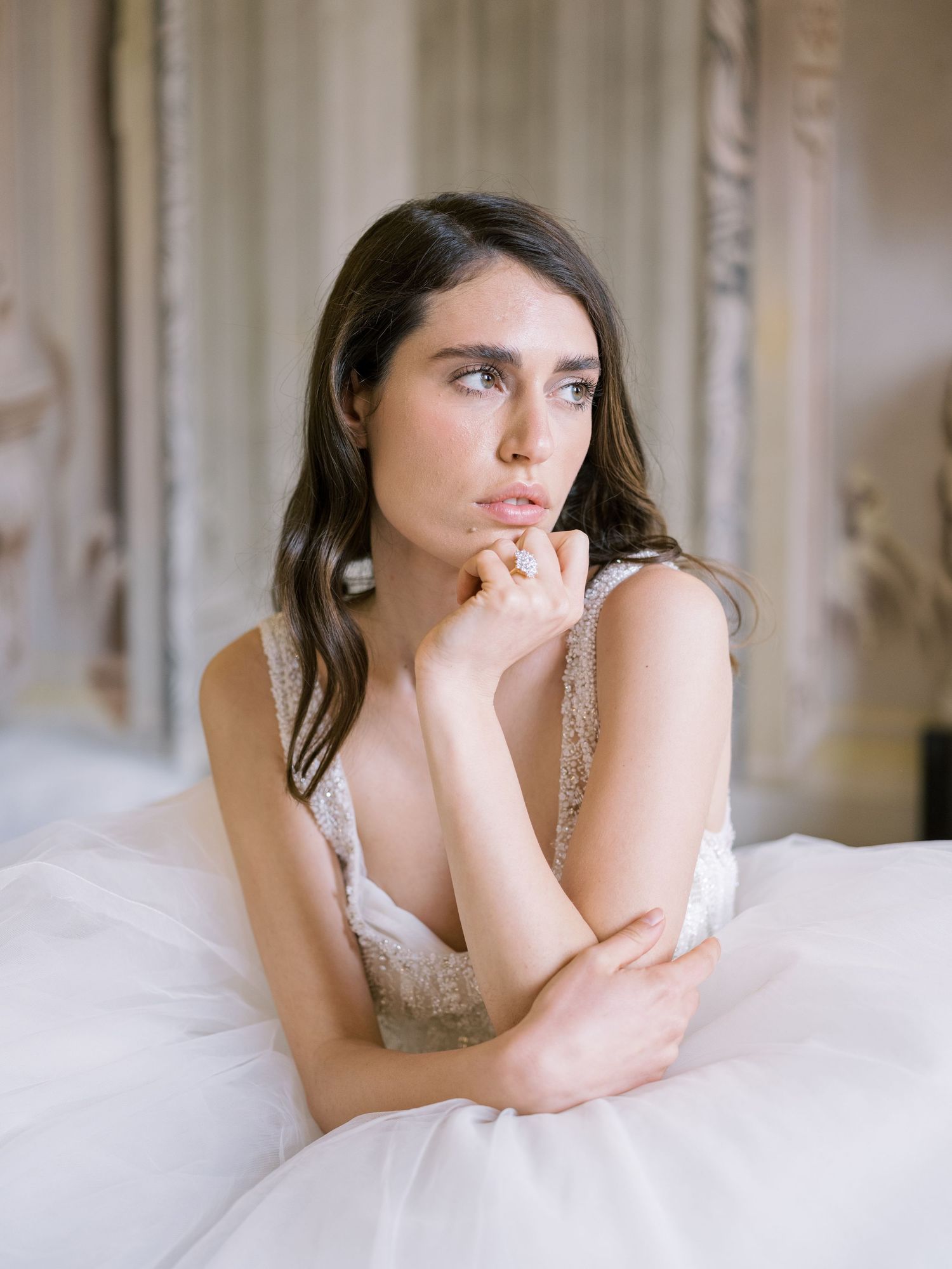 Dreamy bridal portrait in white gown with delicate lace details.