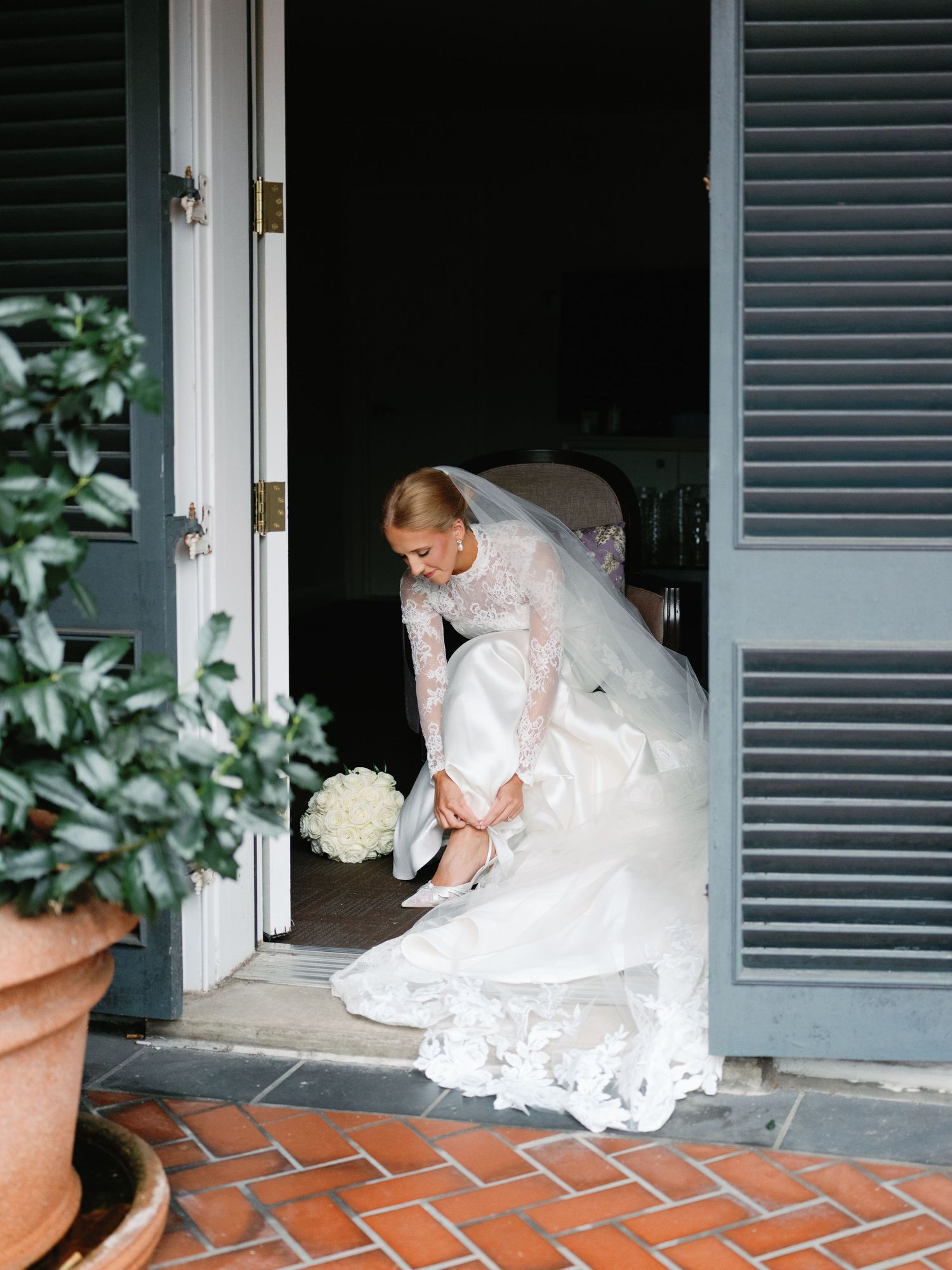 Series of shots showing bride in white dress preparing on a brick porch with blue shutters.